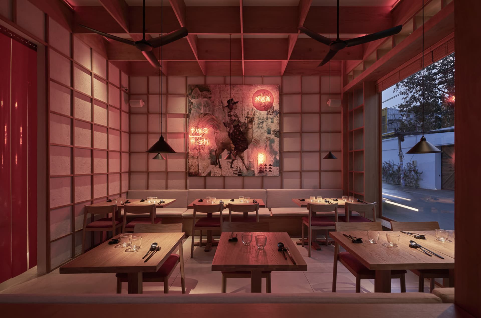 Warm and inviting Asian restaurant interior with wooden floors and tables, traditional decorations, and a cozy atmosphere