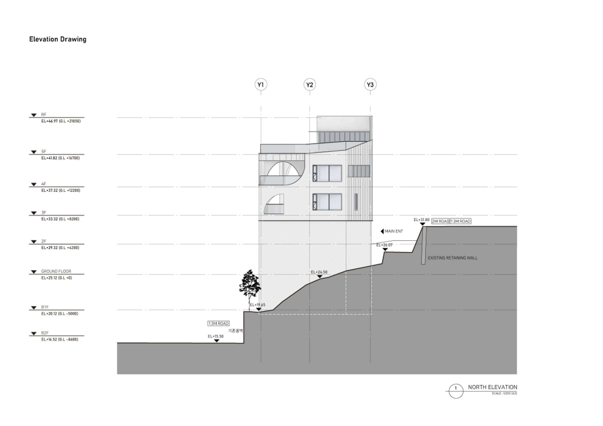 A modern building on a hillside with a large window extending across its facade, suggesting a sense of scale and grandeur