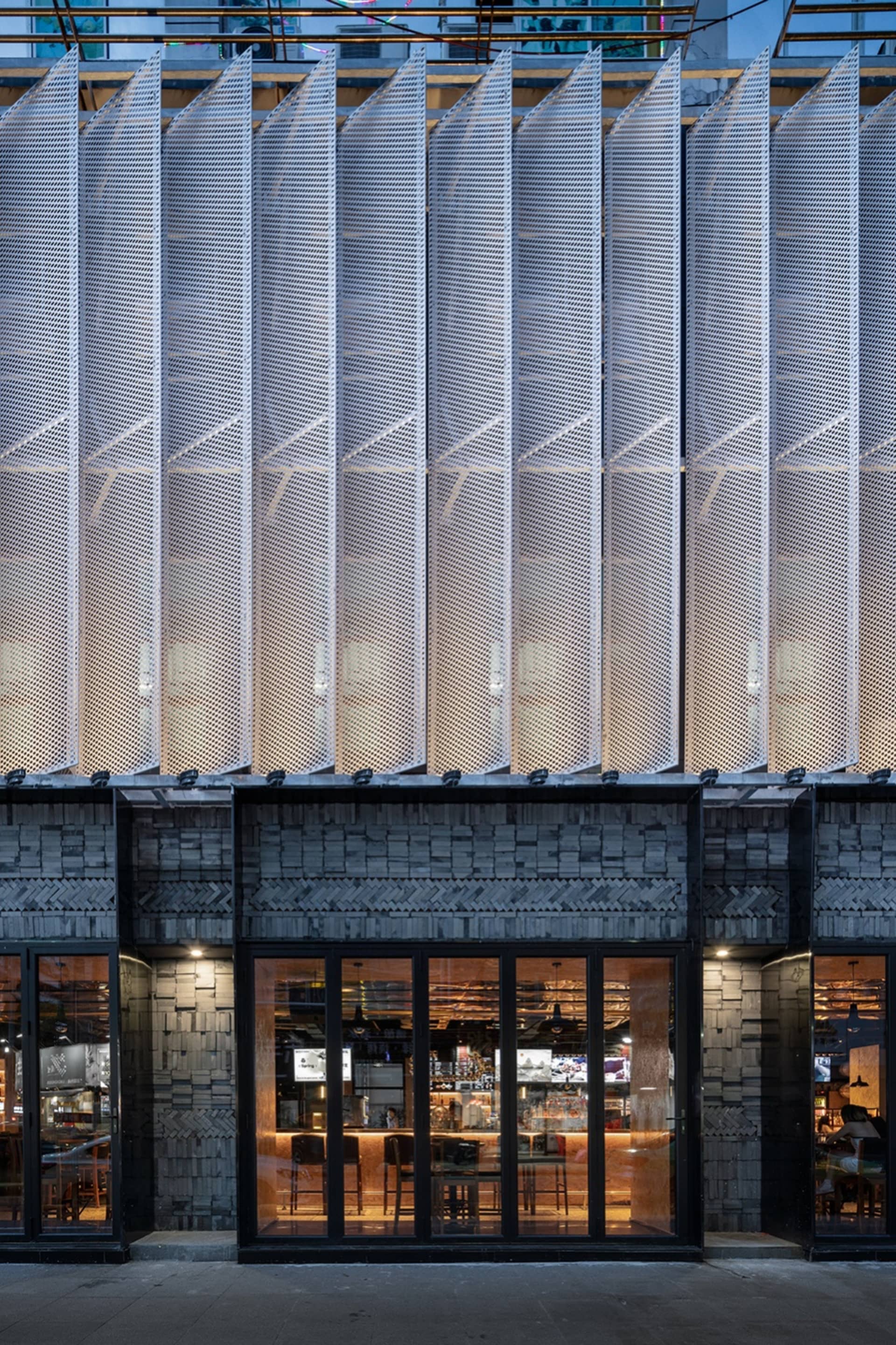 A modern building with large glass windows, allowing natural light to illuminate the interior spaces