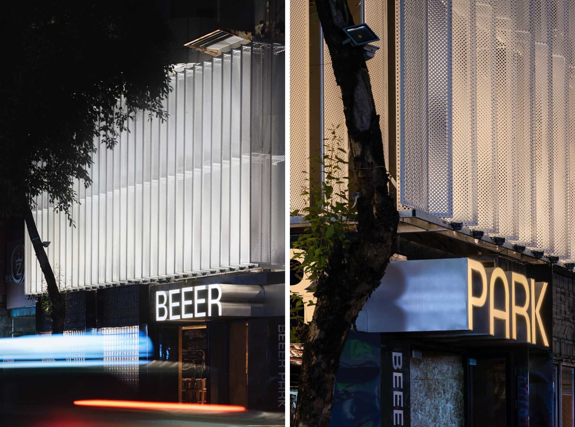 A modern building with a large glass wall and trees in the background, set against a blurred urban environment
