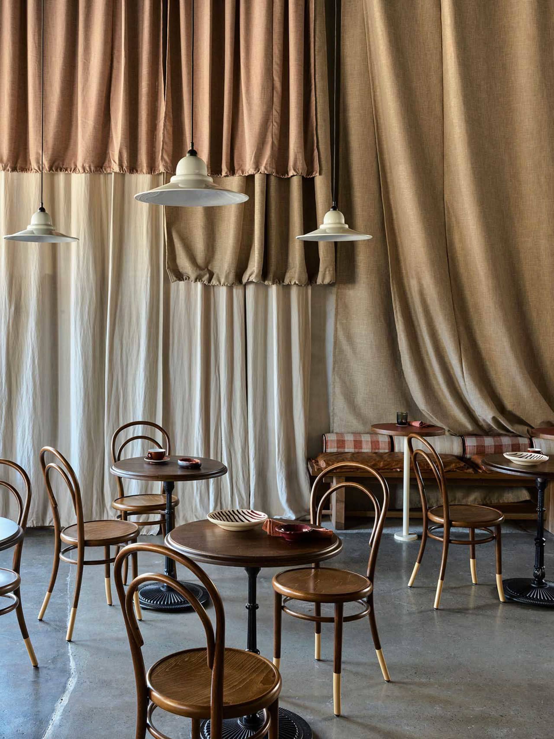 Modern restaurant interior with wooden tables and chairs, creating a warm and inviting atmosphere
