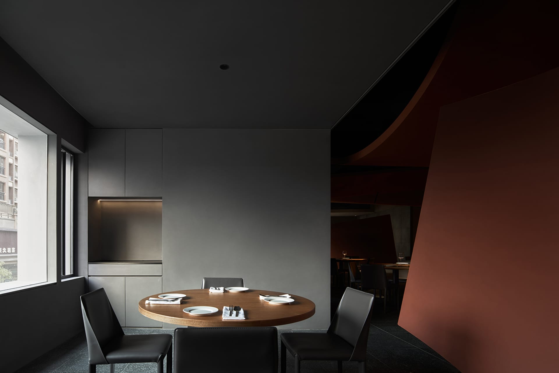 A clean and inviting restaurant interior with a wooden table and chairs, ready for dining