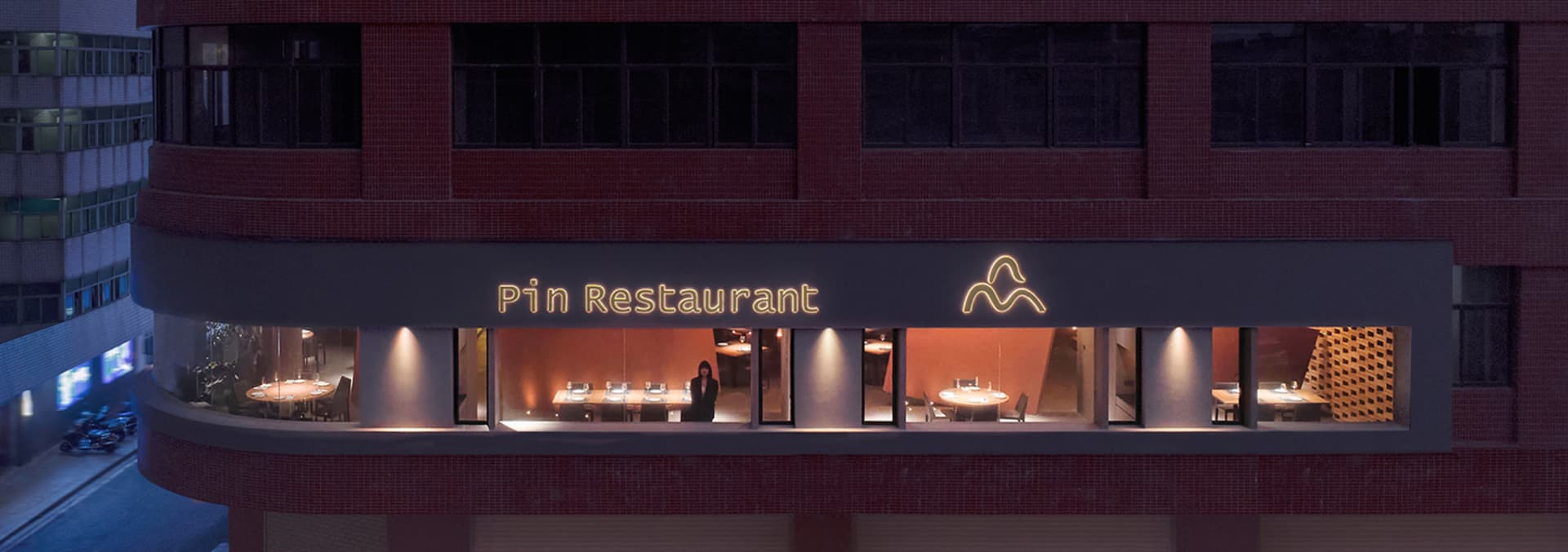 A well-lit restaurant dining area with tables and chairs, creating a cozy atmosphere for people to enjoy meals together