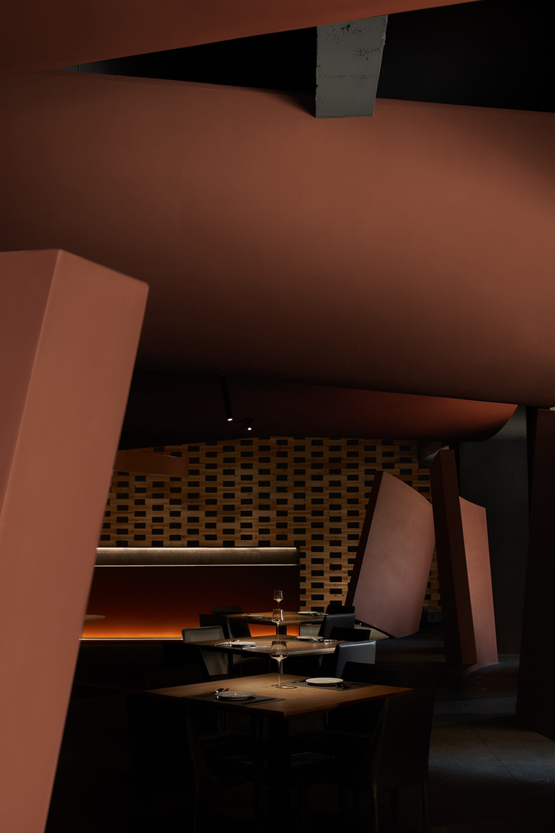 Elegant dining area with wooden furniture, wine glasses, and a sophisticated atmosphere