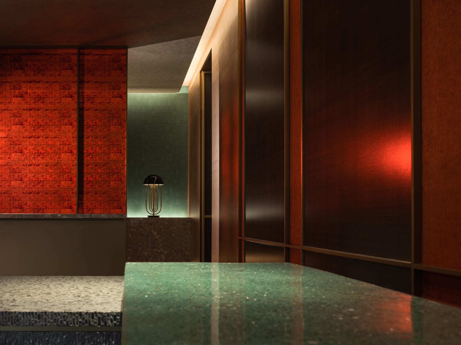 Bathroom with a large green marble countertop, two doors, and a central lamp