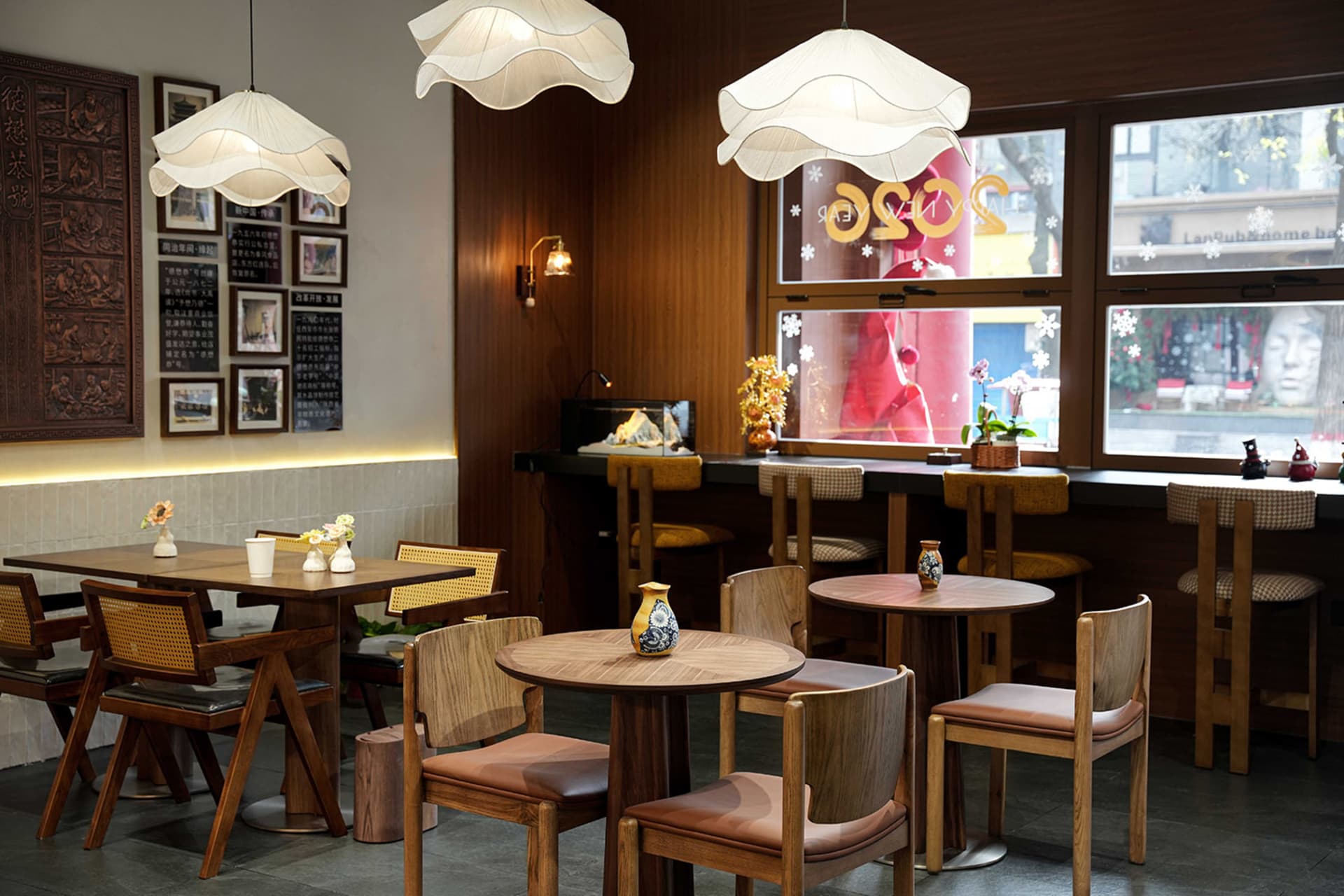 Warm and inviting restaurant interior with wooden tables and chairs, multiple dining tables and chairs, and a cozy atmosphere