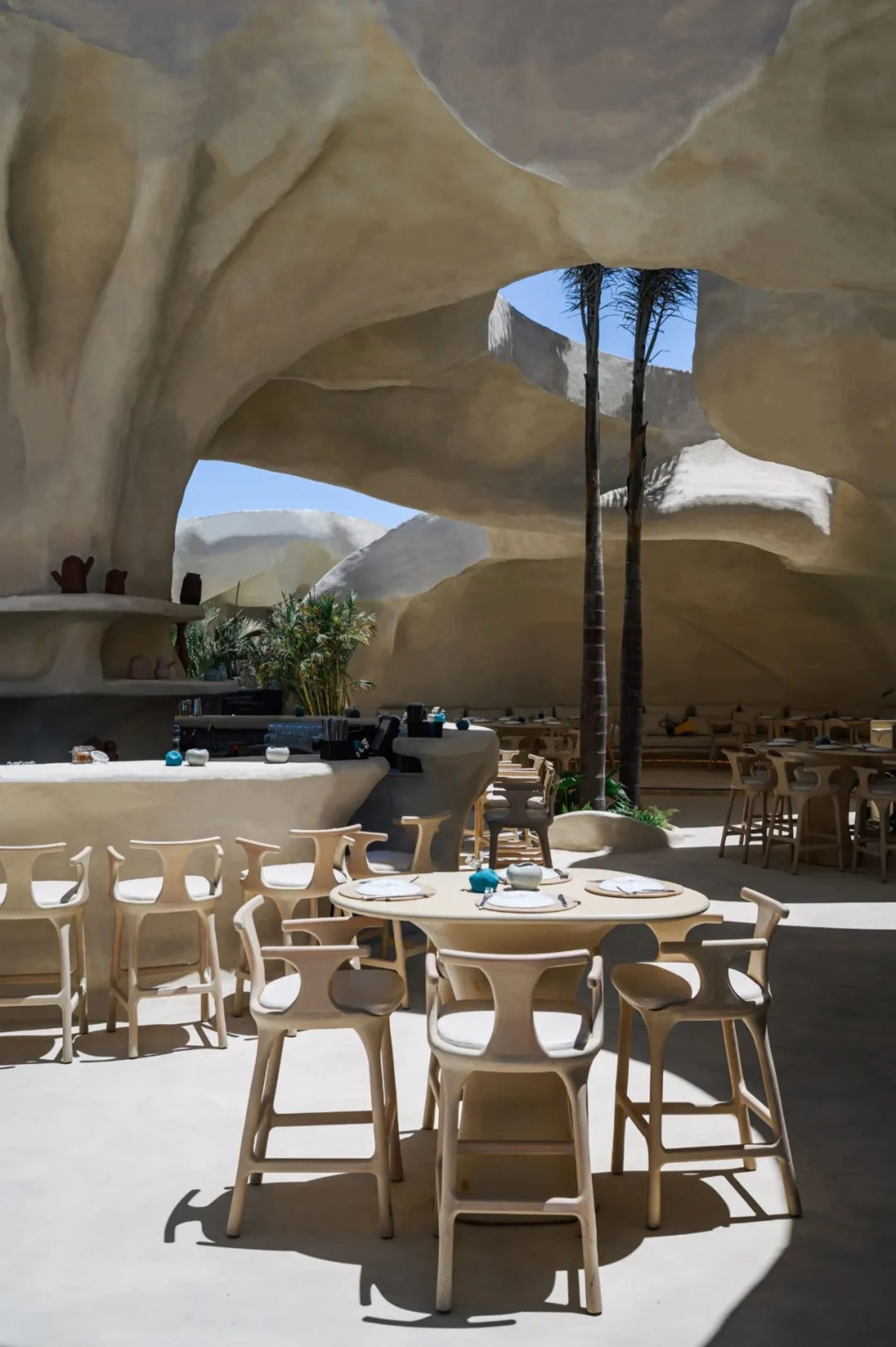 A spacious restaurant interior with multiple dining tables and chairs, creating an inviting atmosphere for a relaxed dining experience