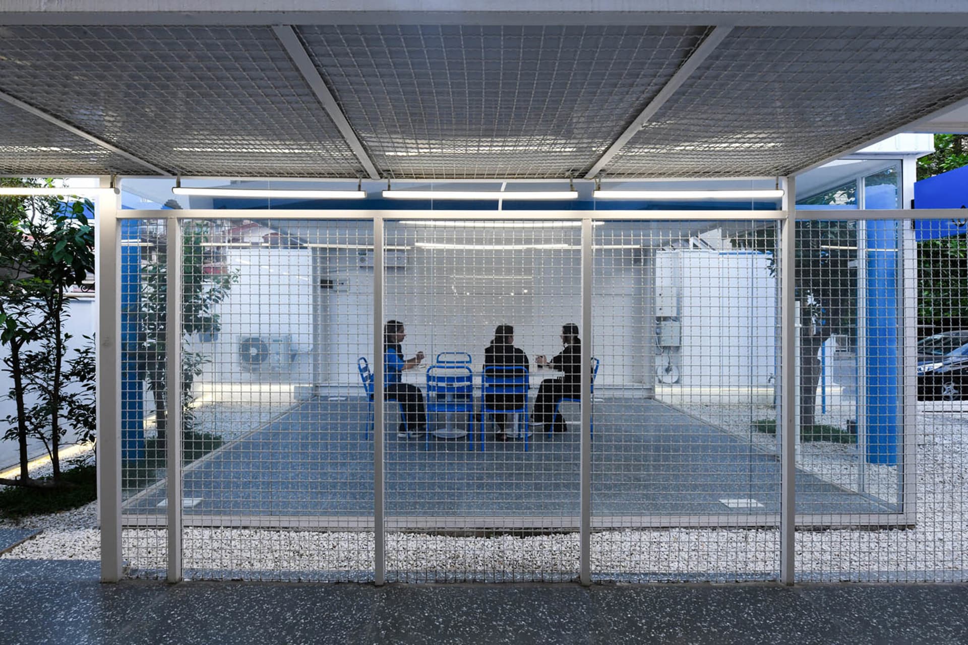 Four people sitting around a dining table in a cozy atmosphere, engaged in conversation