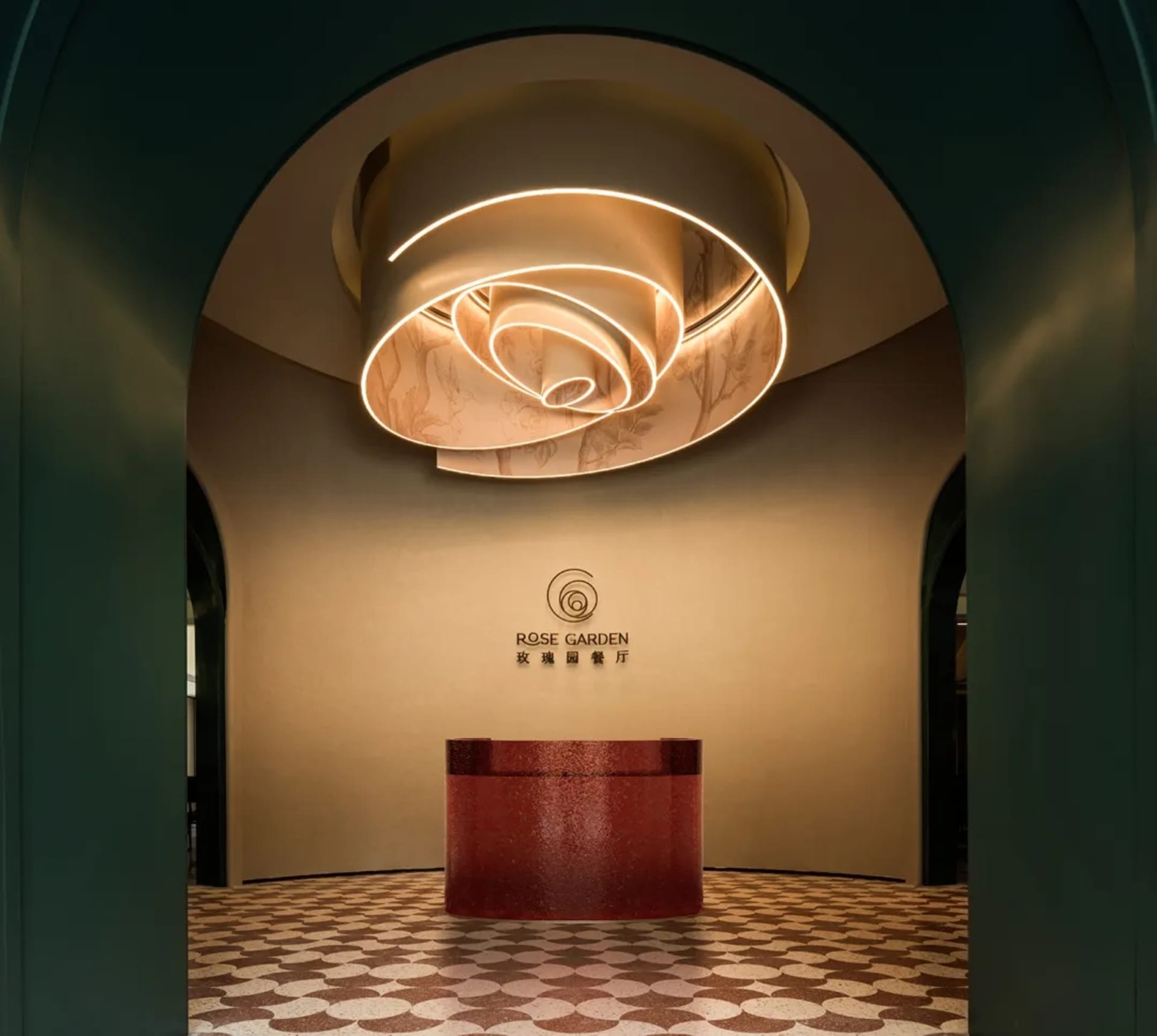 A modern hotel lobby with a red countertop, likely made of marble or granite, in an elegant and inviting atmosphere