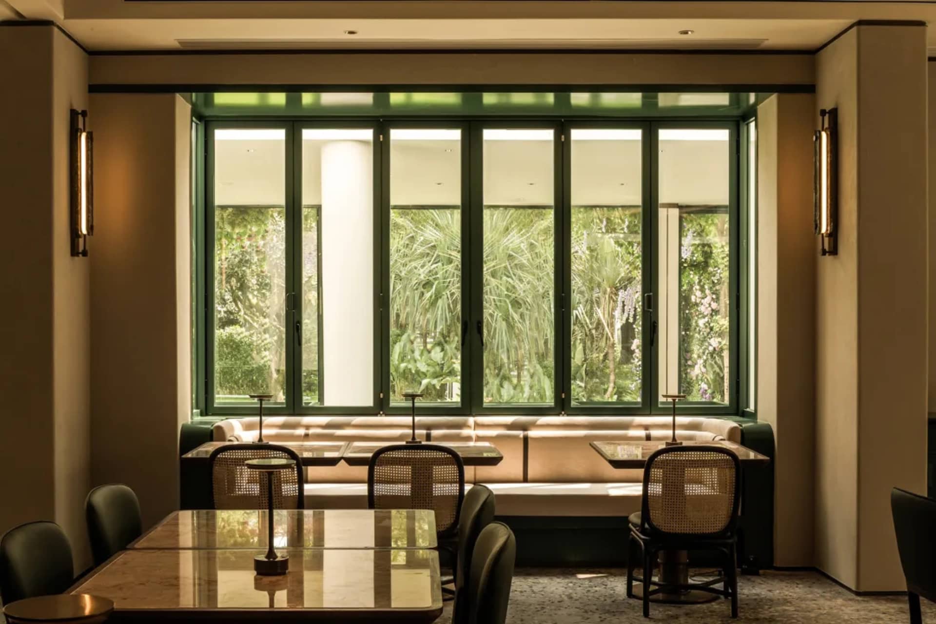 Dining area with multiple tables and chairs, well-lit for a comfortable atmosphere
