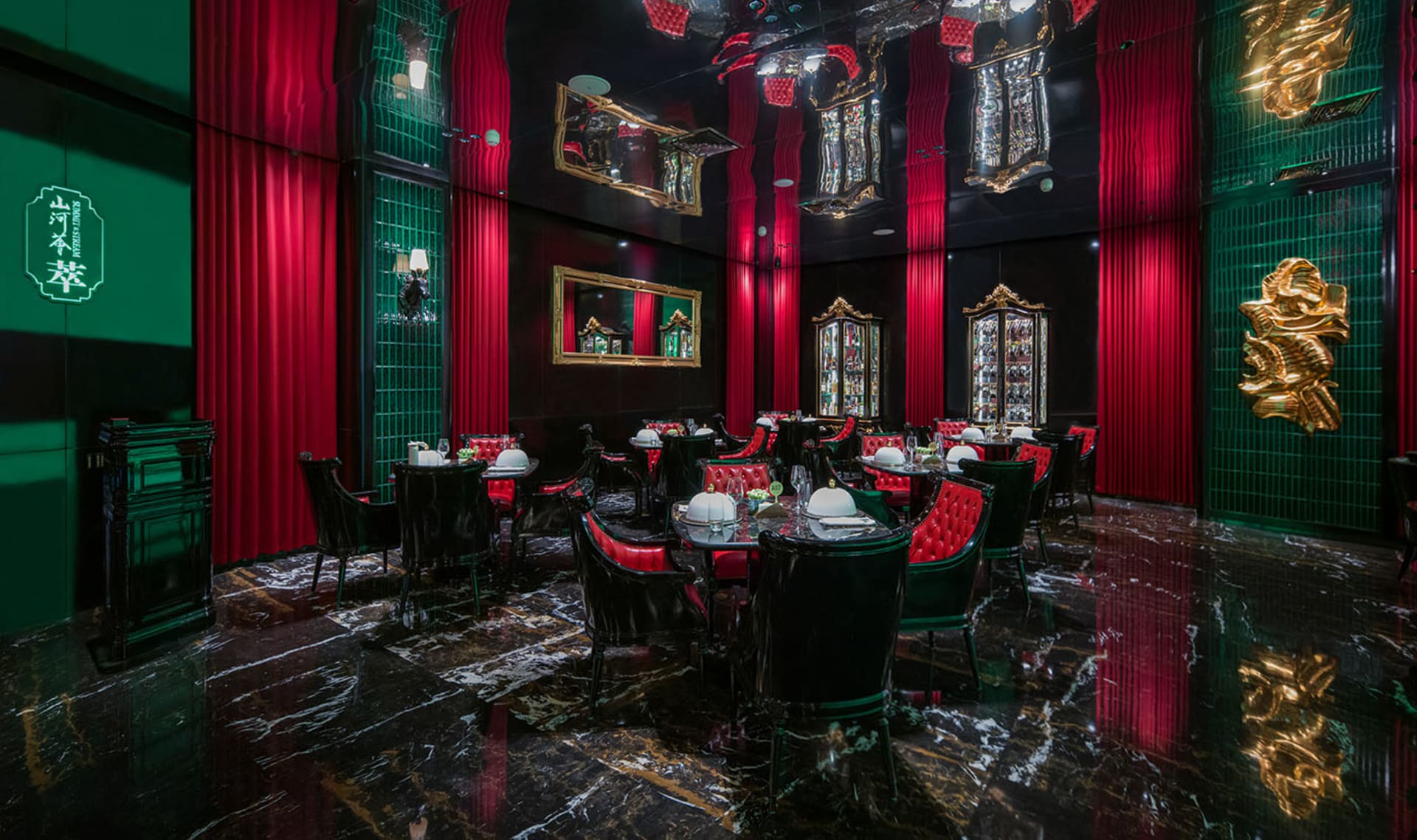 Ornate dining area with a large table, black leather chairs, and wine glasses, set in an elegant and sophisticated atmosphere