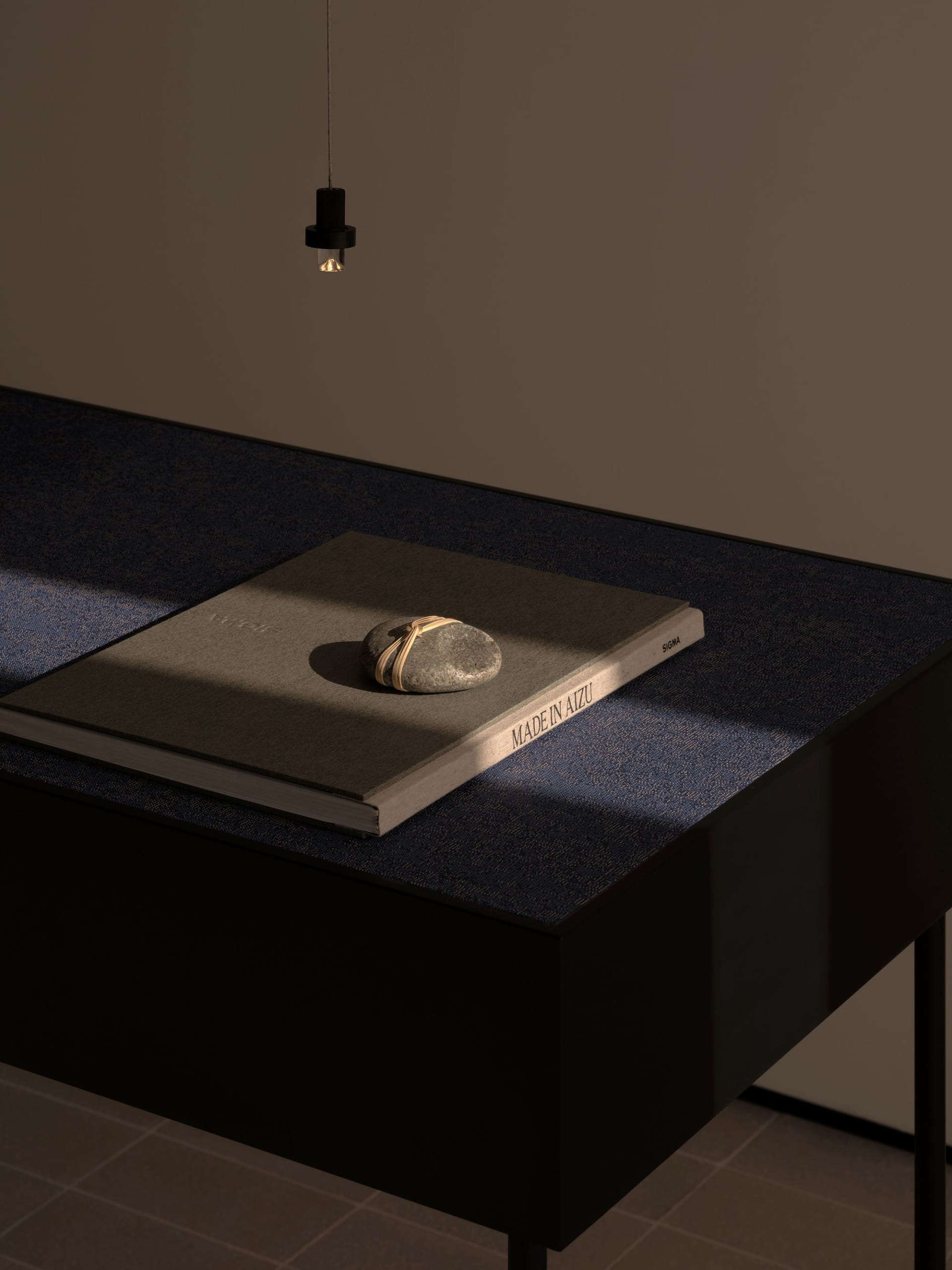 A wooden table with a book on top, in front of a wall, with a calm and organized atmosphere