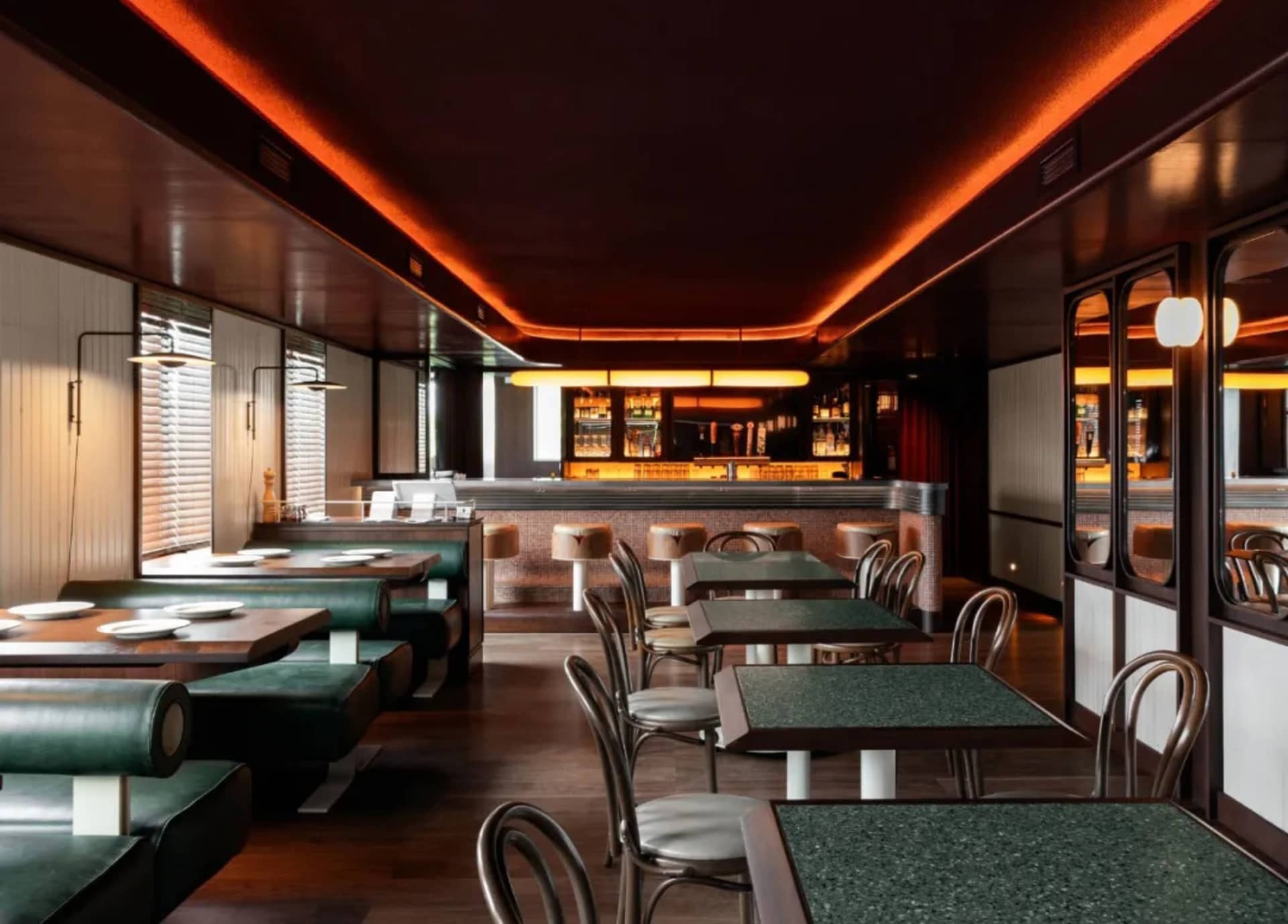 Empty restaurant interior with multiple dining tables and chairs, inviting atmosphere, and clean layout