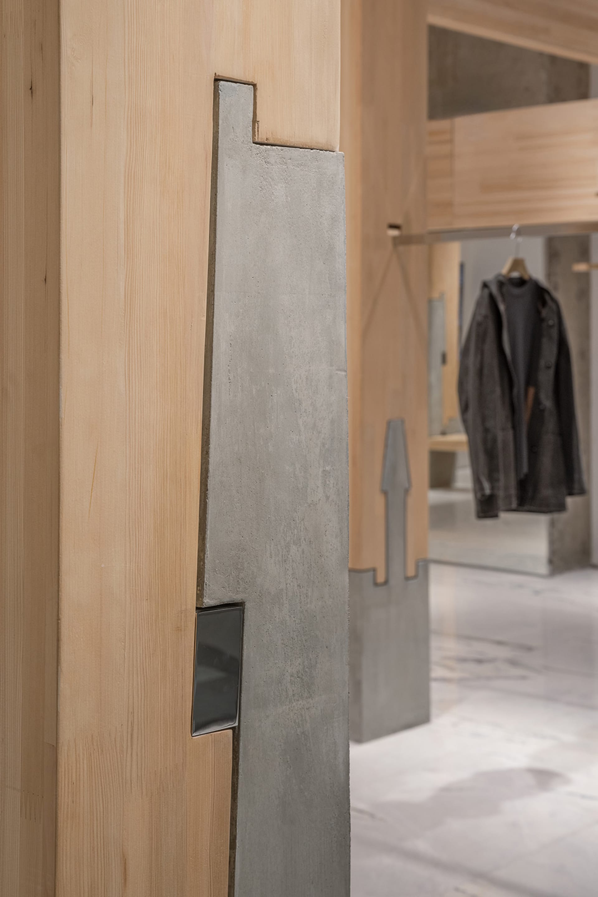 A well-organized retail space with clothing items on walls and in display areas, creating a stylish atmosphere with jackets and coats on display