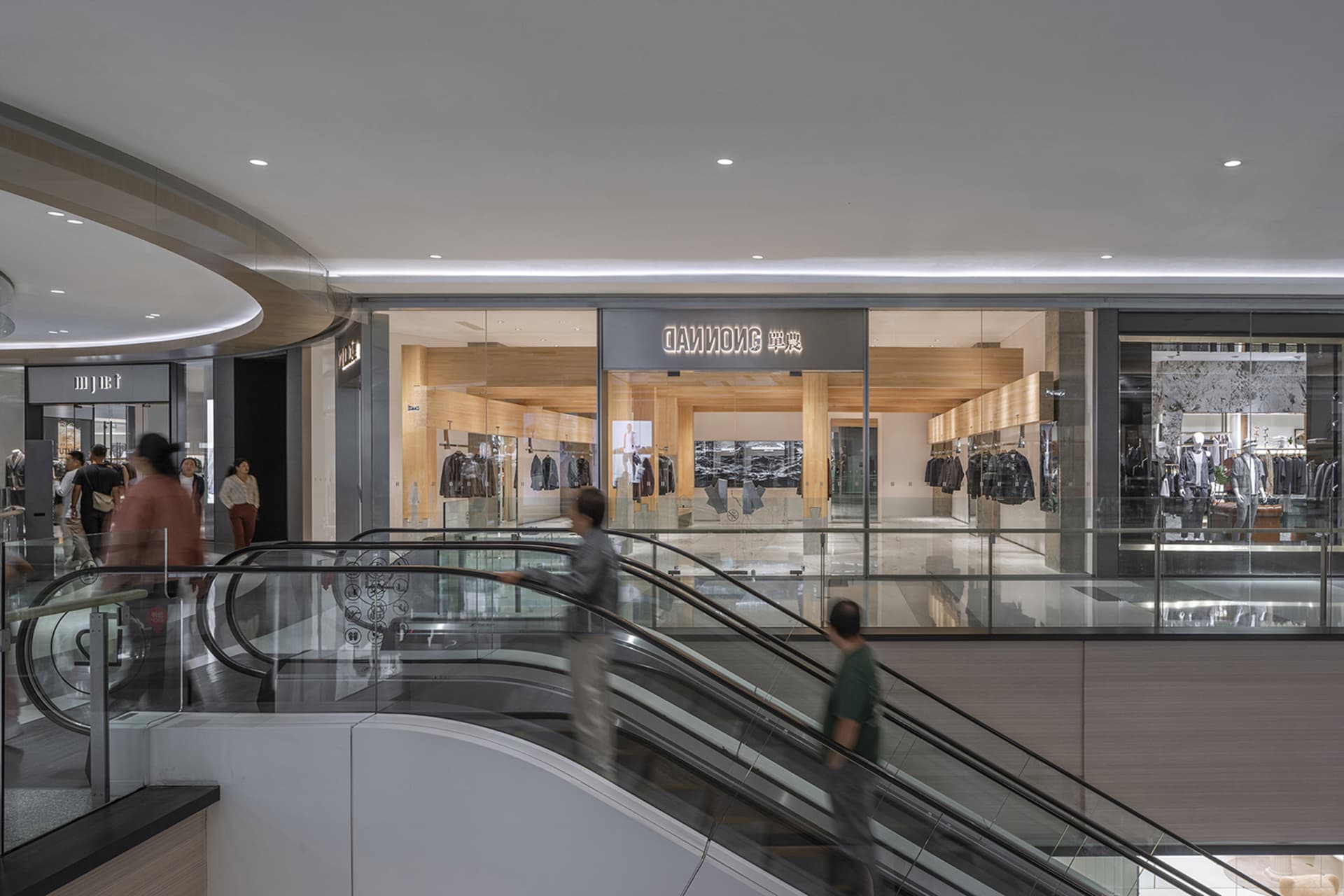 A well-organized retail space with glass windows showcasing merchandise, natural light, and customers browsing through the store