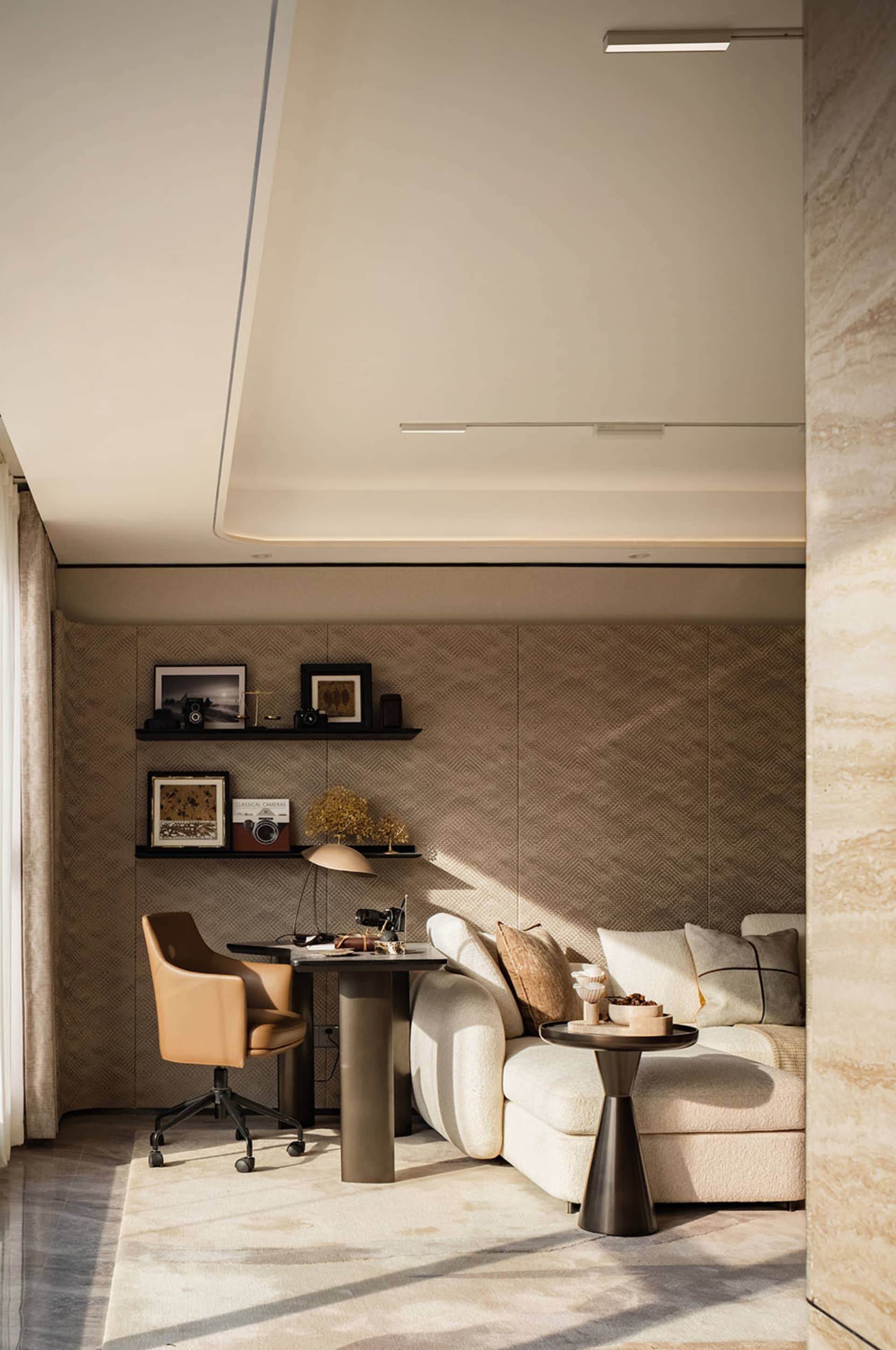 A well-lit living area with a couch, chair, dining table, and decorative items, featuring wood and fabric materials and a bookshelf