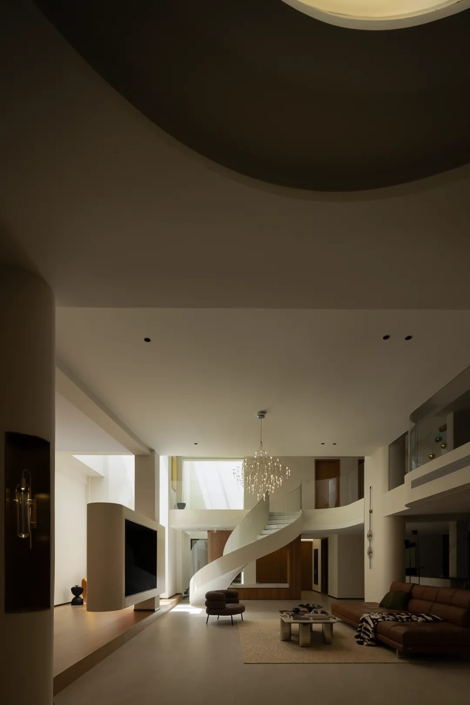 A modern house with a spiral staircase, clean lines, and minimalist elements, featuring marble or stone floors and walls, and well-lit interior