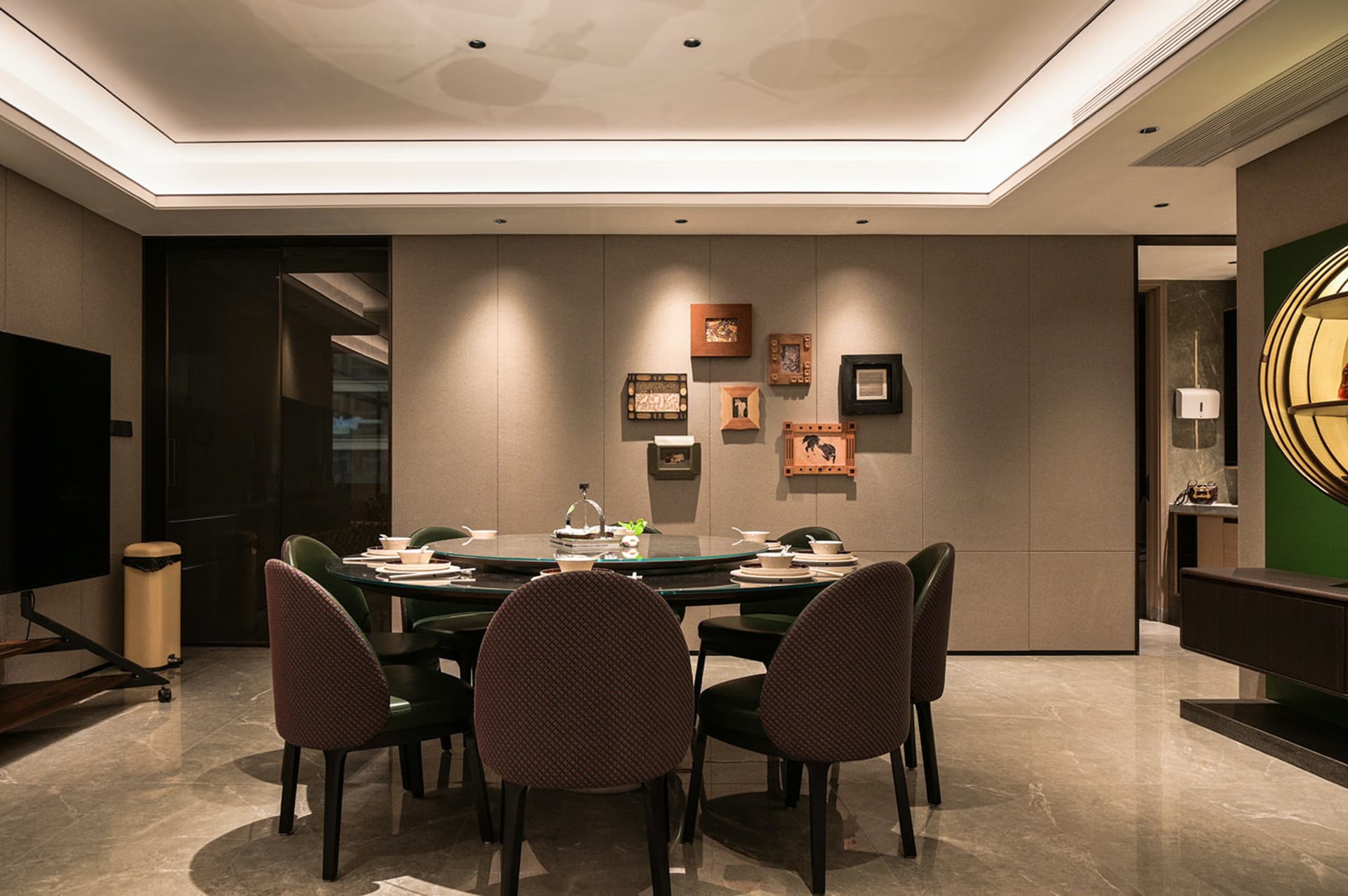 A well-lit dining area with a large wooden table, multiple chairs, and decorative vases, set for a meal with various tableware and utensils