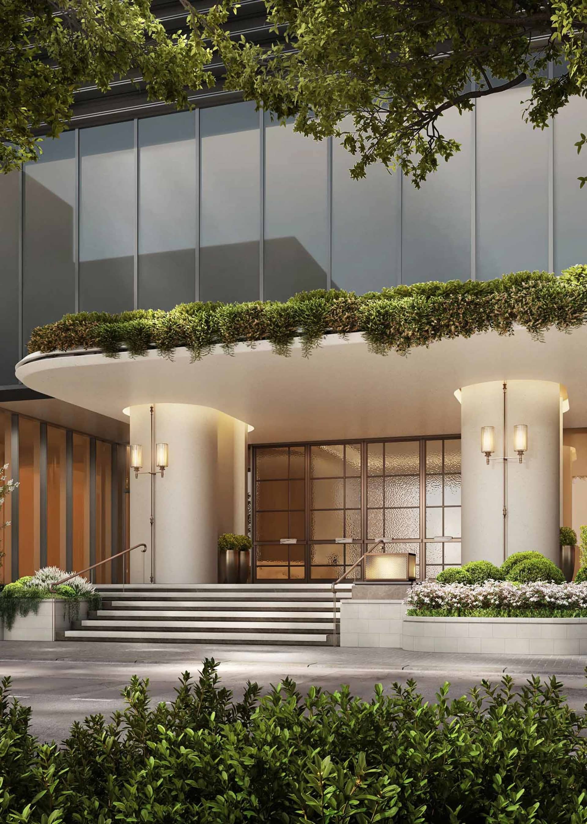 Modern building with a large glass wall and balcony on the second floor, surrounded by potted plants and natural elements