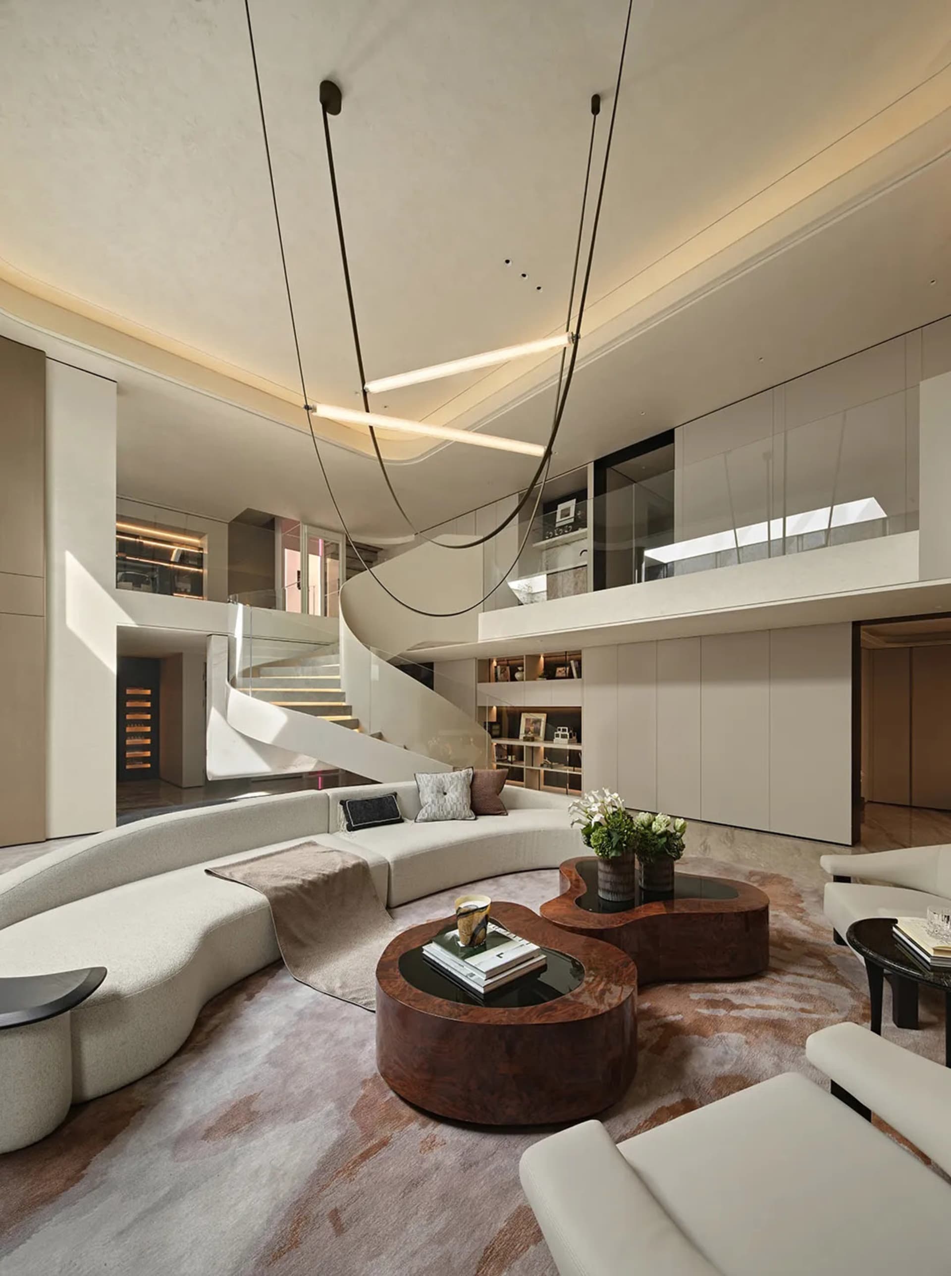 Sleek modern living room with a large couch, chairs, potted plants, and clean lines
