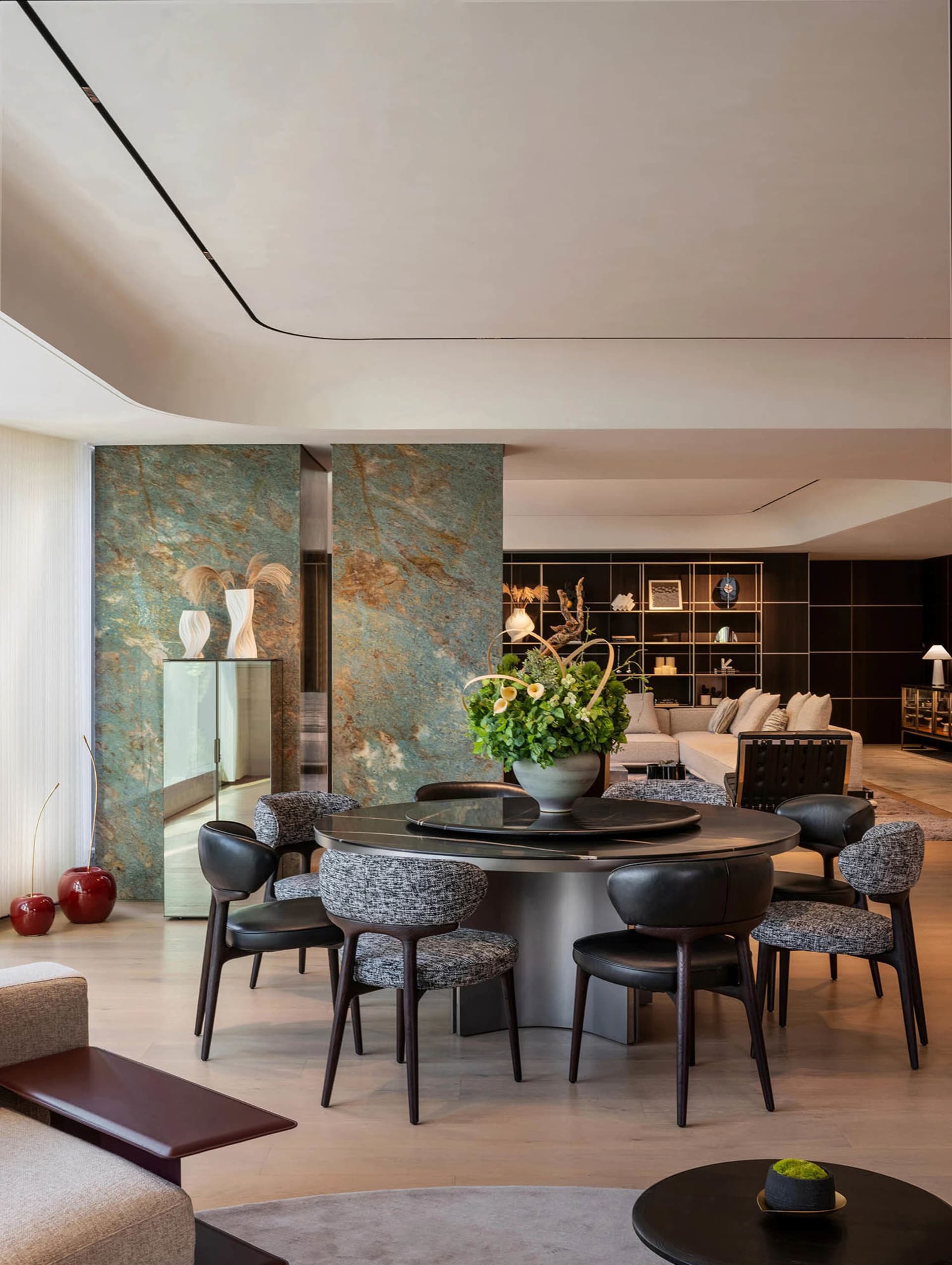 A well-lit open concept living area with a dining table, chairs, and a couch, creating a comfortable and inviting space for socializing and meals