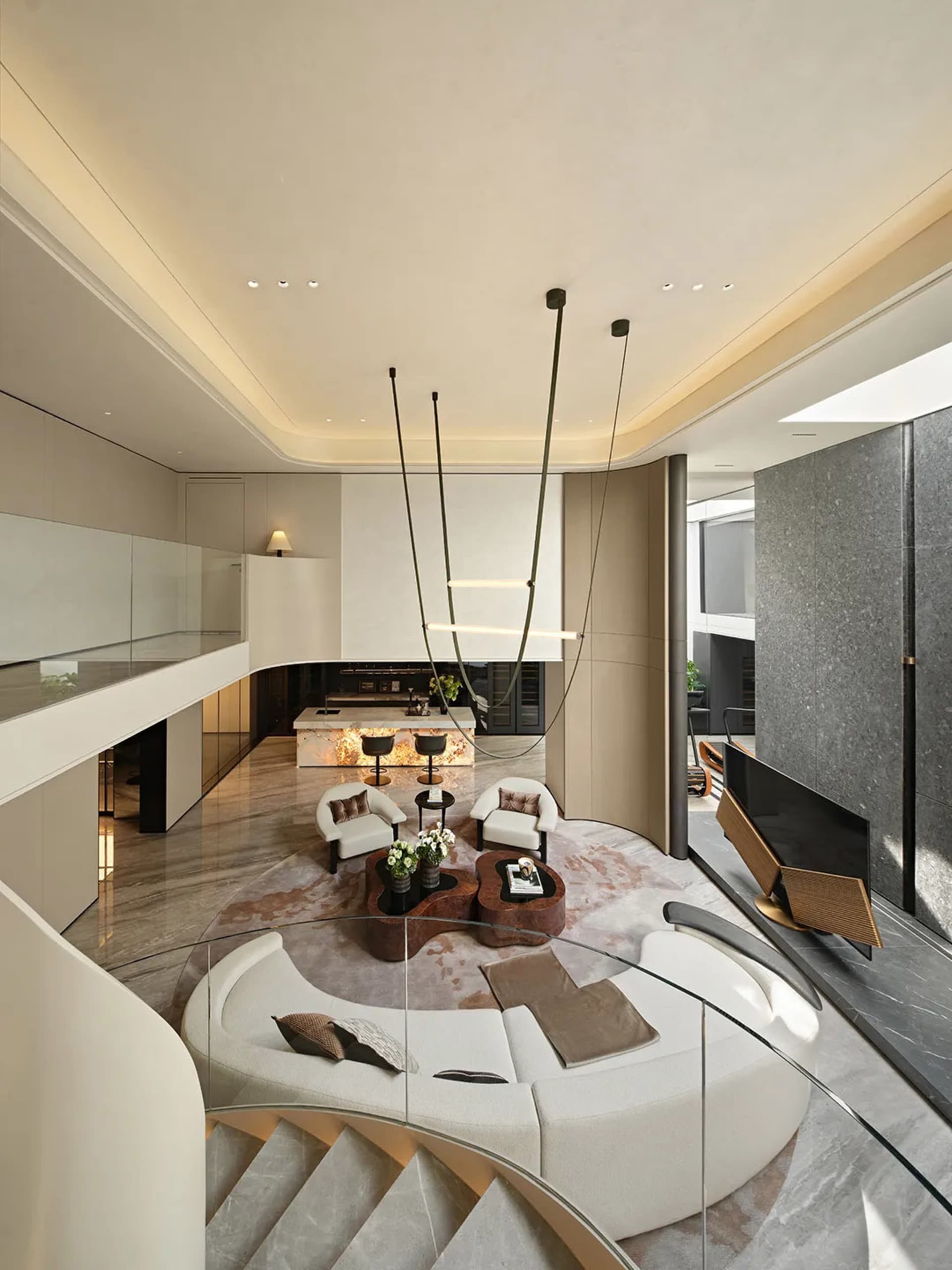 Open modern living space with glass walls, white walls, and natural light from the glass wall, featuring two couches, three chairs, and a potted plant