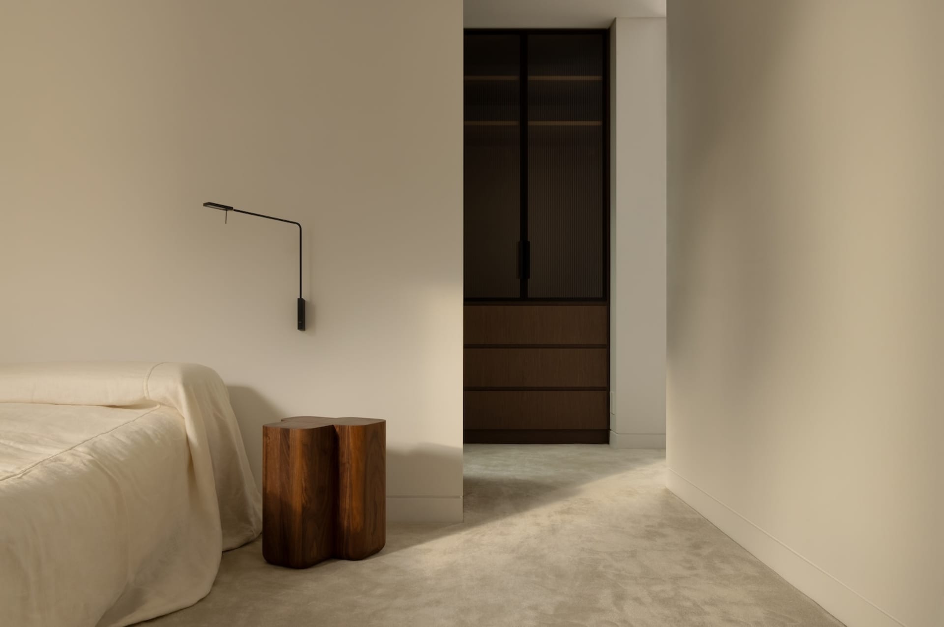 Cozy modern living space with wooden floors, walls, and furniture, featuring a bed and two wooden stools