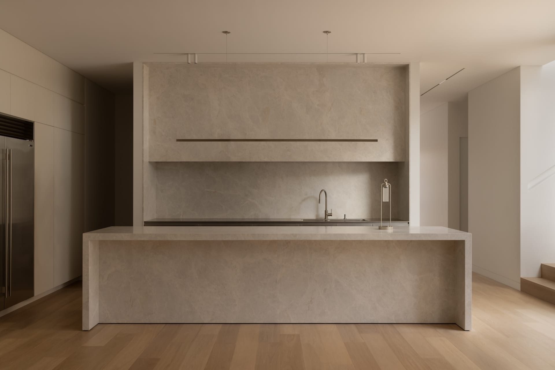 Modern kitchen with a marble countertop island featuring two sinks and a refrigerator, set against a clean and minimalist backdrop