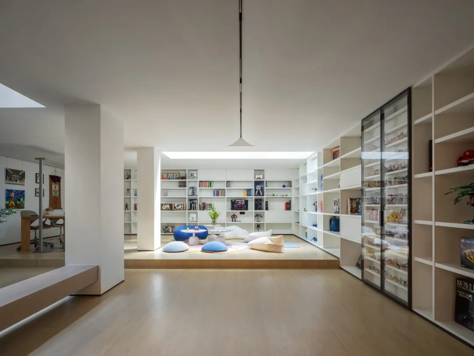 Open living and dining area with a bookshelf, couches, TV, and dining table, creating a cozy and inviting atmosphere