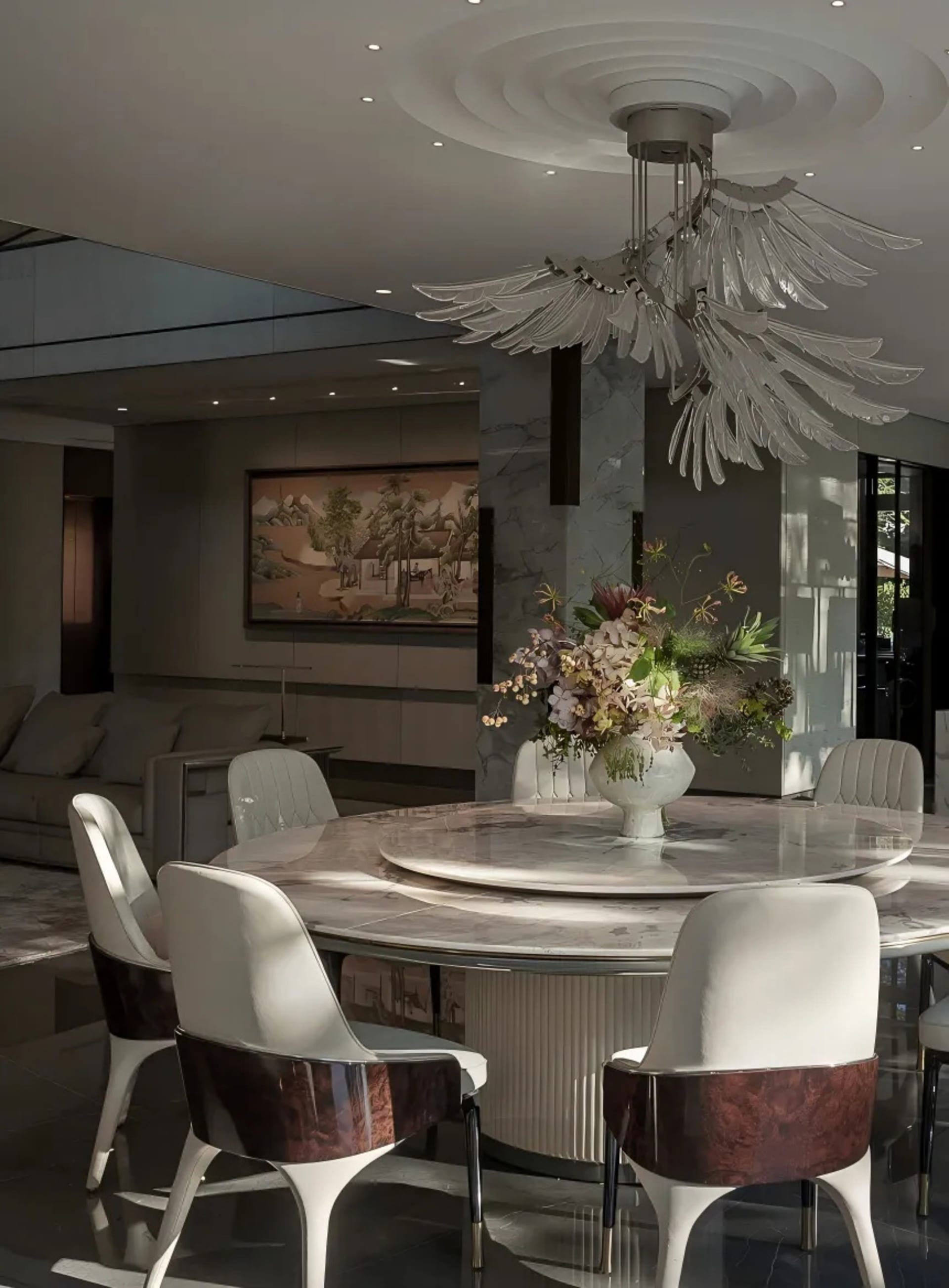 A well-designed living area with a dining table surrounded by chairs, a vase, and a couch, creating a comfortable seating arrangement