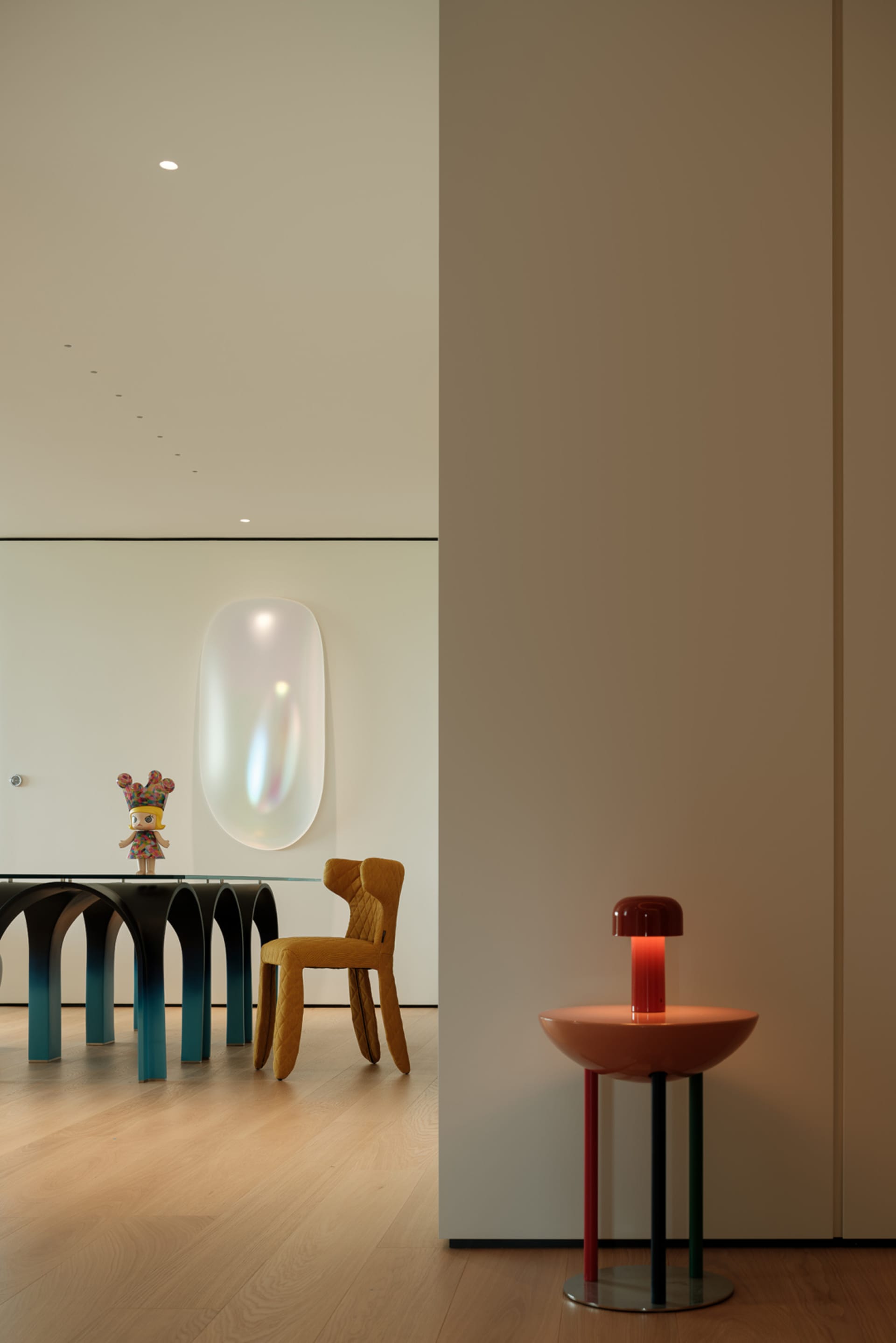 A modern dining space with a glass table, surrounded by chairs and decorated with vases, creating a cozy and inviting atmosphere
