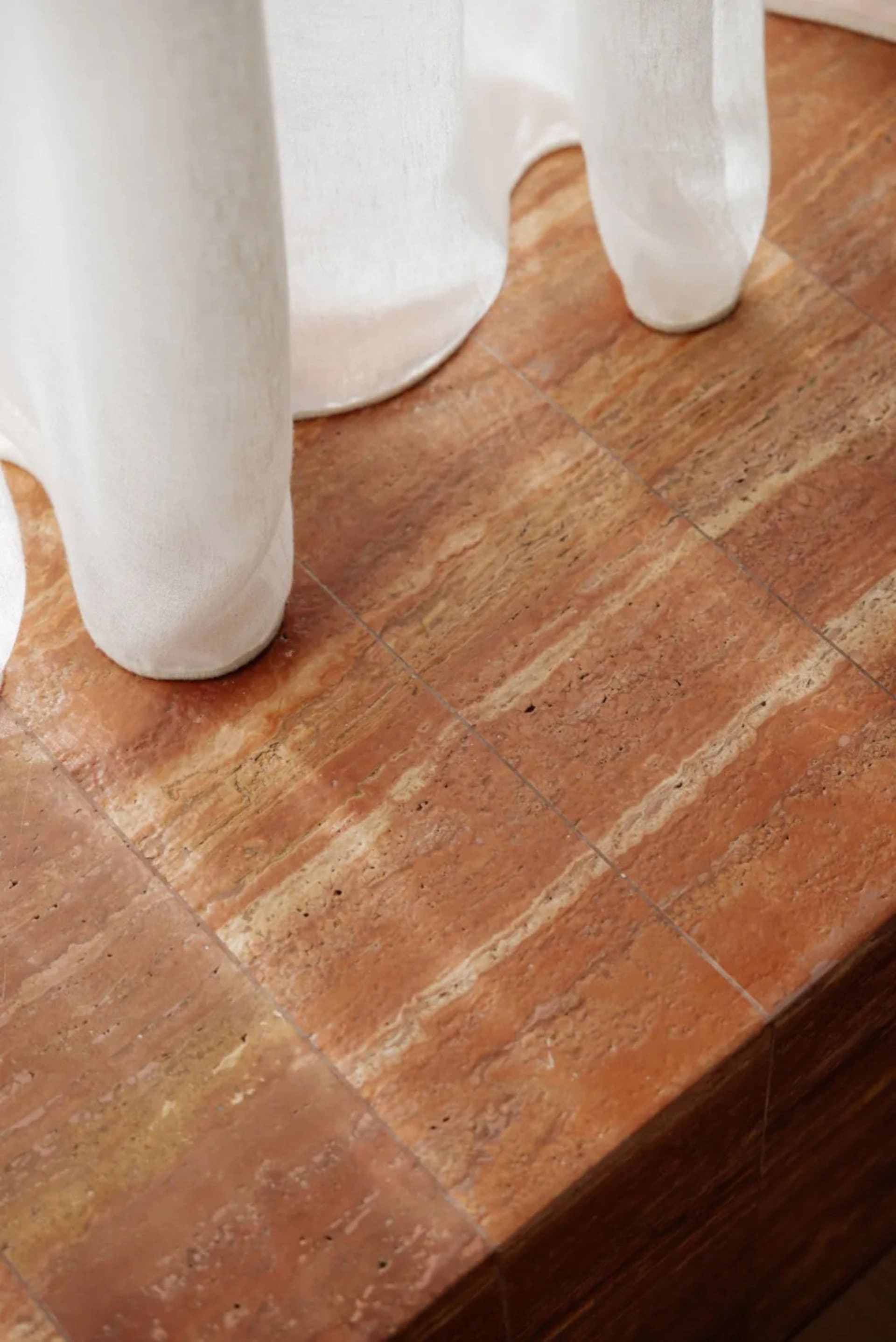 A room with a marble tile floor featuring a striped pattern, creating an elegant and sophisticated atmosphere