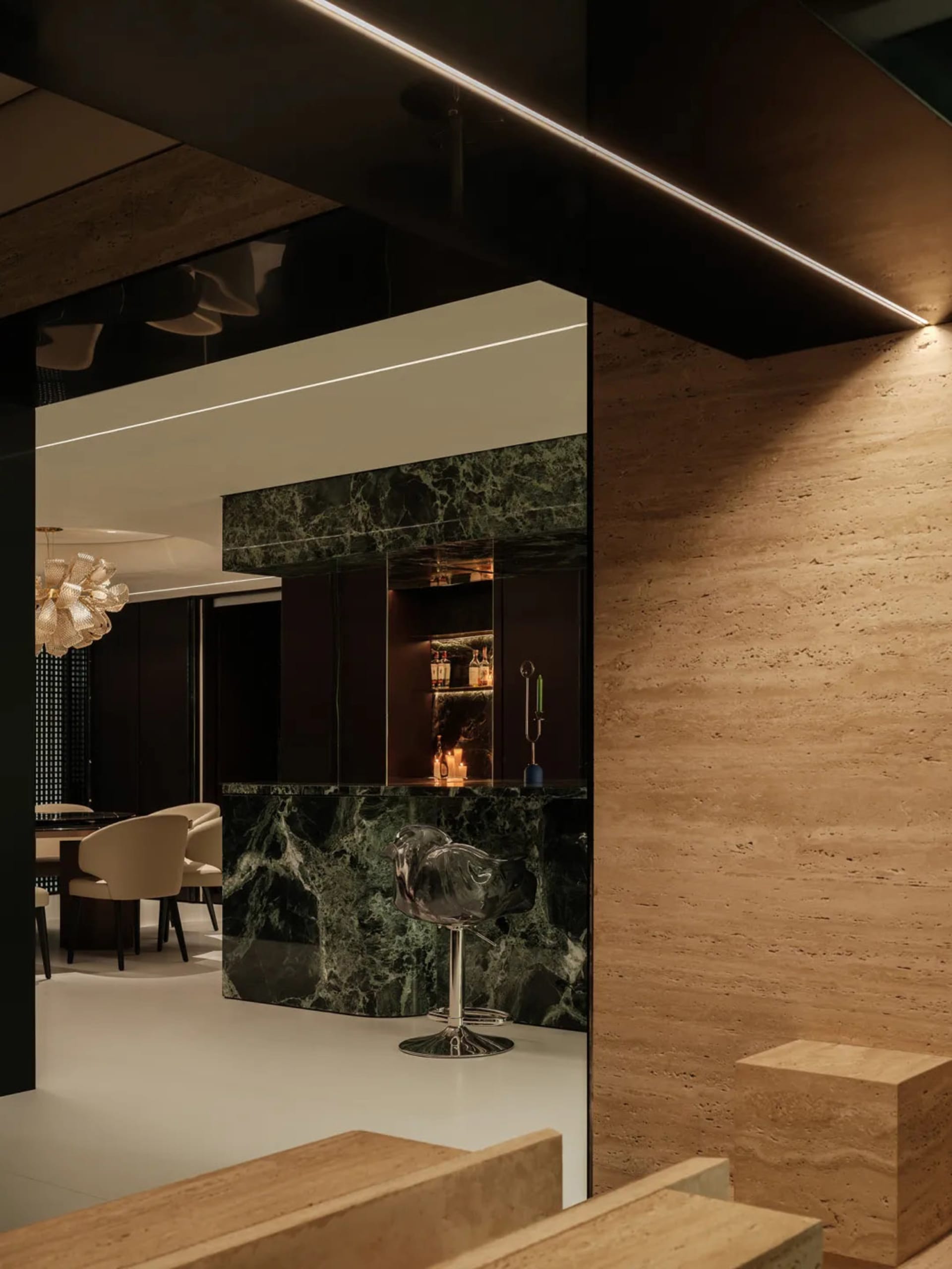 Sophisticated living space with a marble bar, two chairs, and a dining table, featuring luxurious marble accents