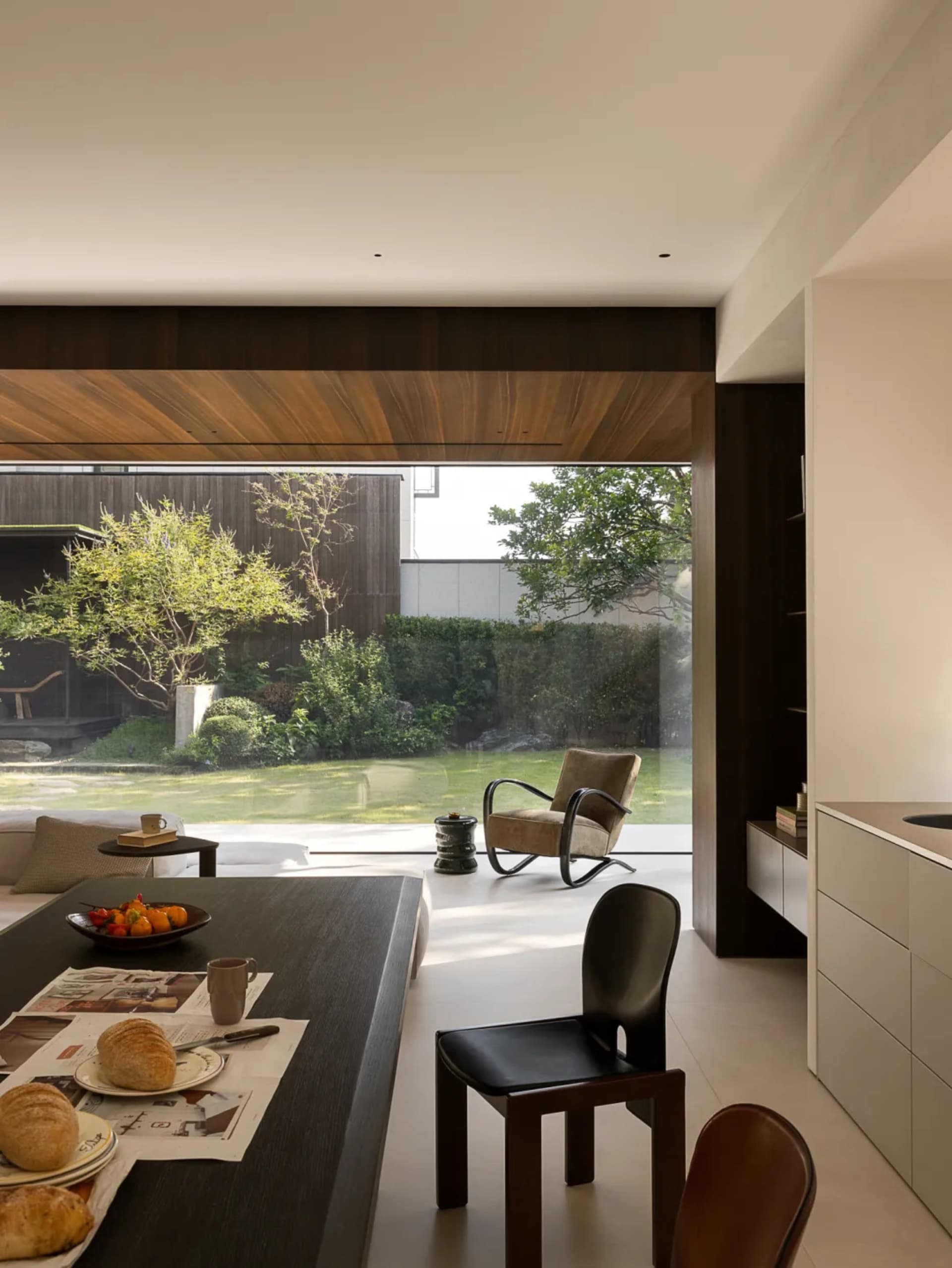 Open living area with wooden floors, white walls, and a mix of furniture and decorative items
