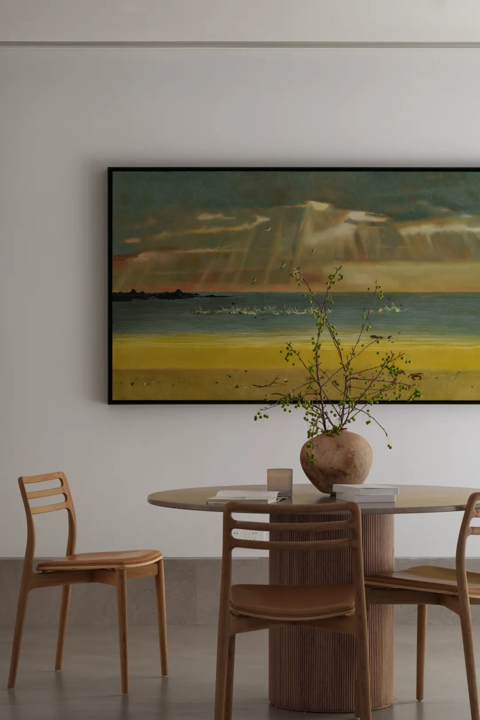 A serene beach scene with sandy shore, ocean waves, and several chairs and a potted plant set against a white background