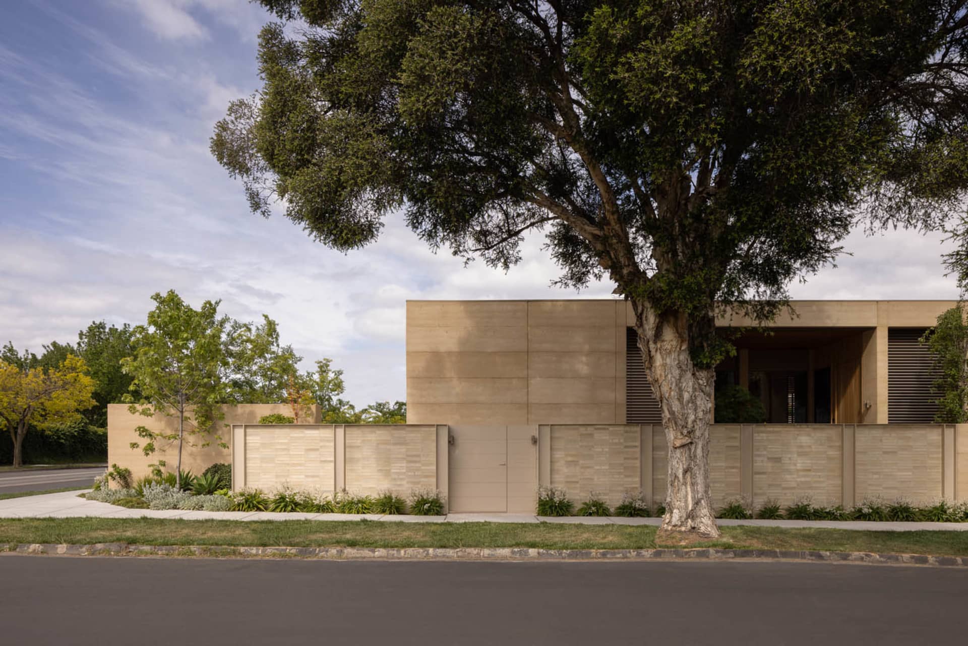 A stone house with a brick facade, surrounded by trees and a serene atmosphere