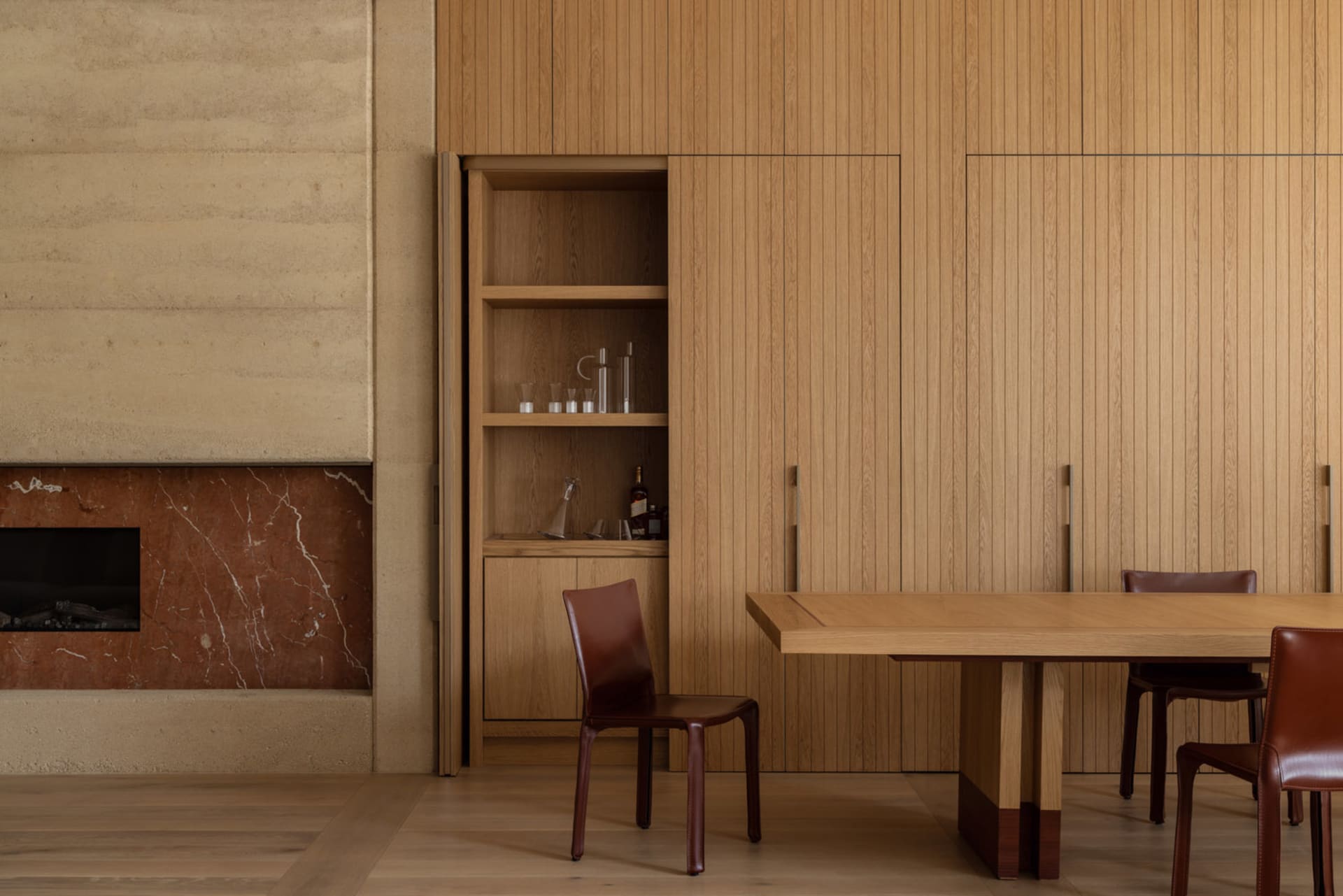 A modern dining space with a wooden table and chairs, surrounded by a warm and inviting atmosphere created by natural materials