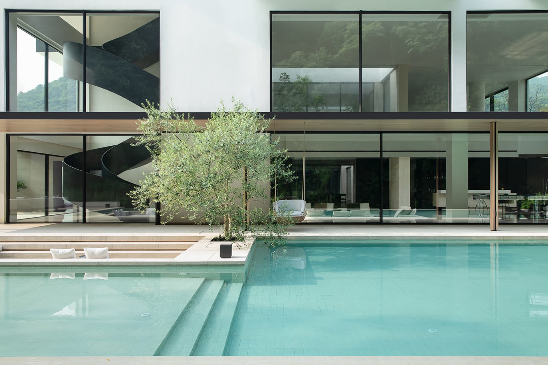 An inviting indoor pool area with seating options and luxurious atmosphere