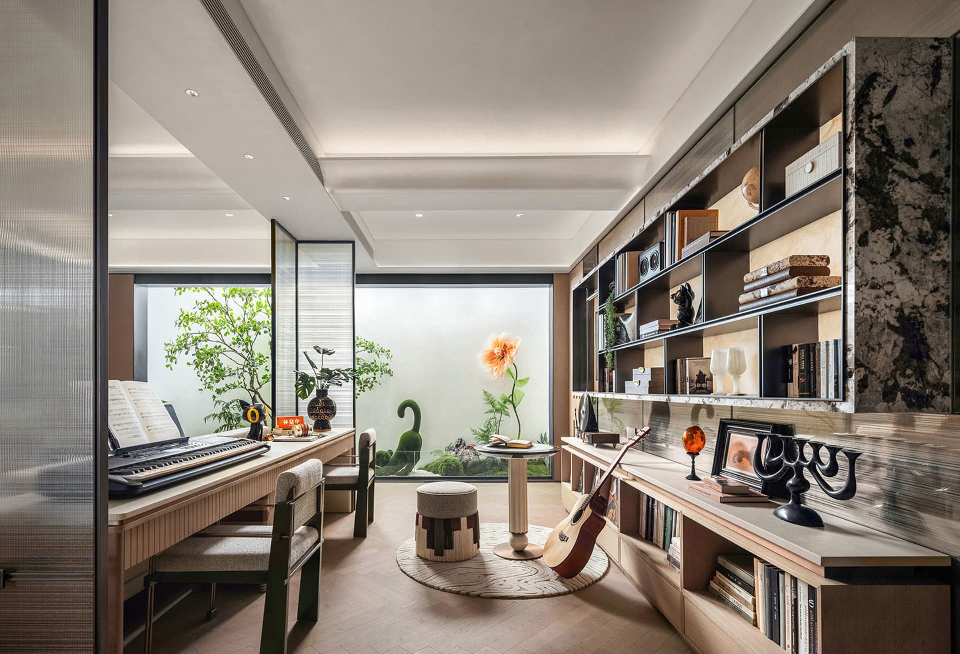 Cozy living room with hardwood floors, white walls, and a piano, featuring furniture, books, and potted plants, well-lit and inviting