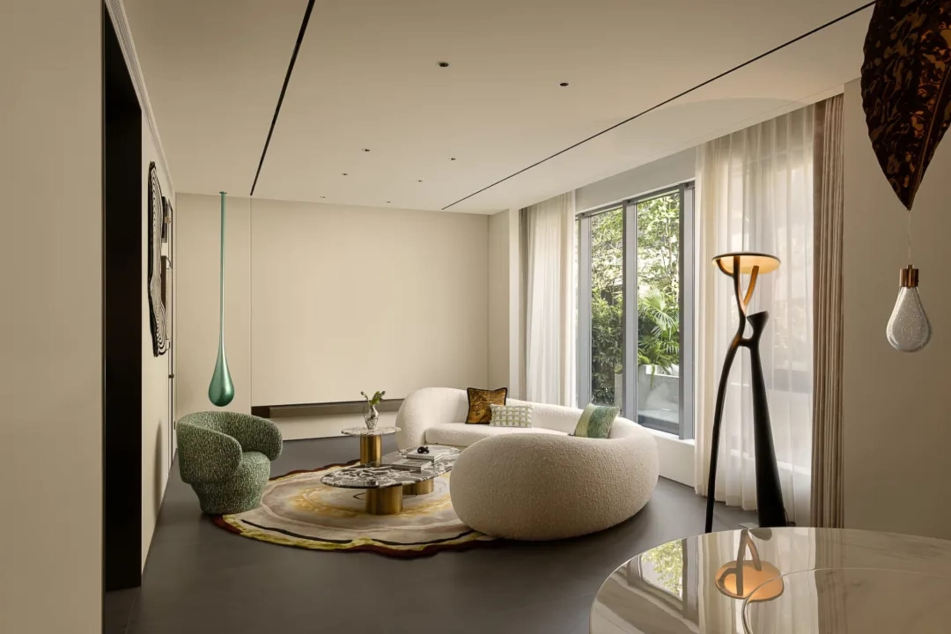 Empty modern living room with white walls, a large window, two couches, chairs, and a dining table