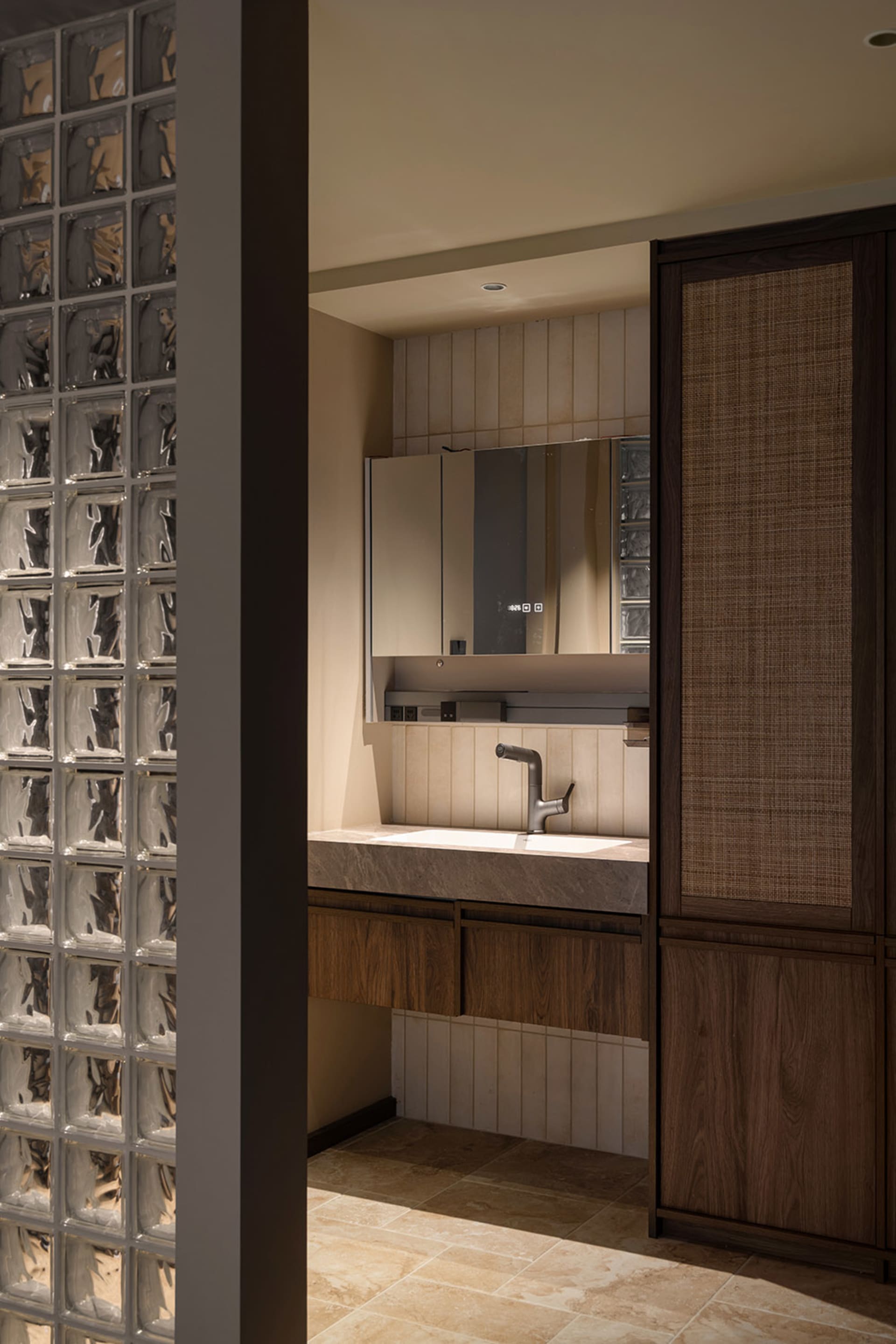 Modern bathroom with a sink, mirror, and wooden cabinetry, featuring clean lines and minimalistic design elements, with bright and airy ambiance