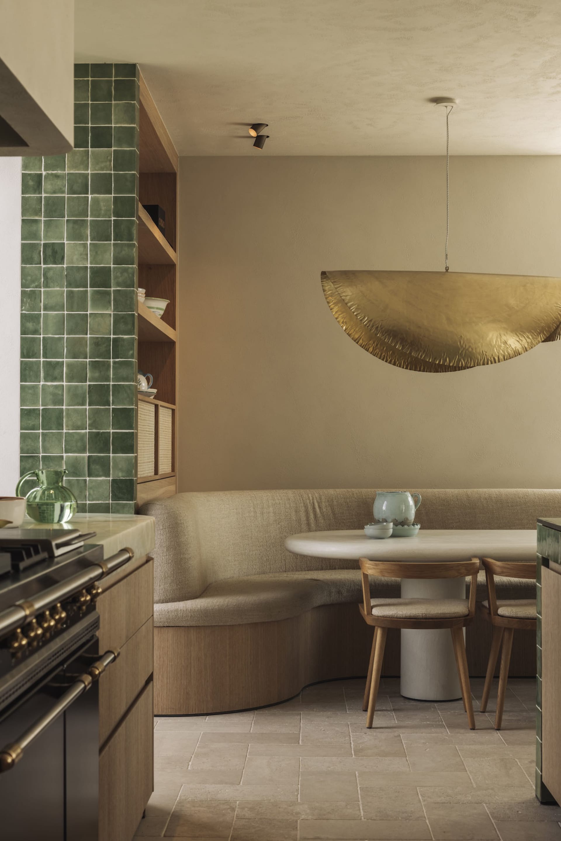 Warm and inviting kitchen and dining area with wooden floors and walls, featuring a cozy seating arrangement and lived-in feel