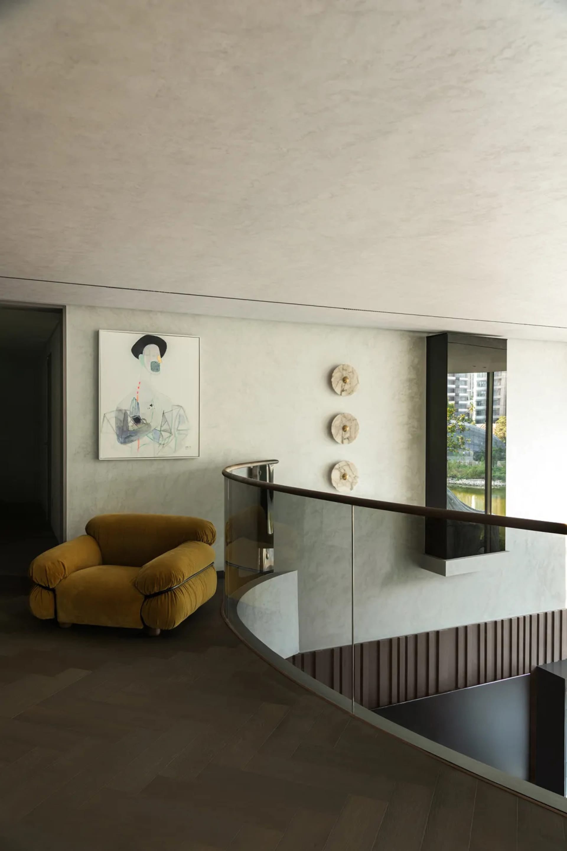 Modern living space with a yellow chair, hardwood floor, and a couch, featuring a modern and inviting atmosphere