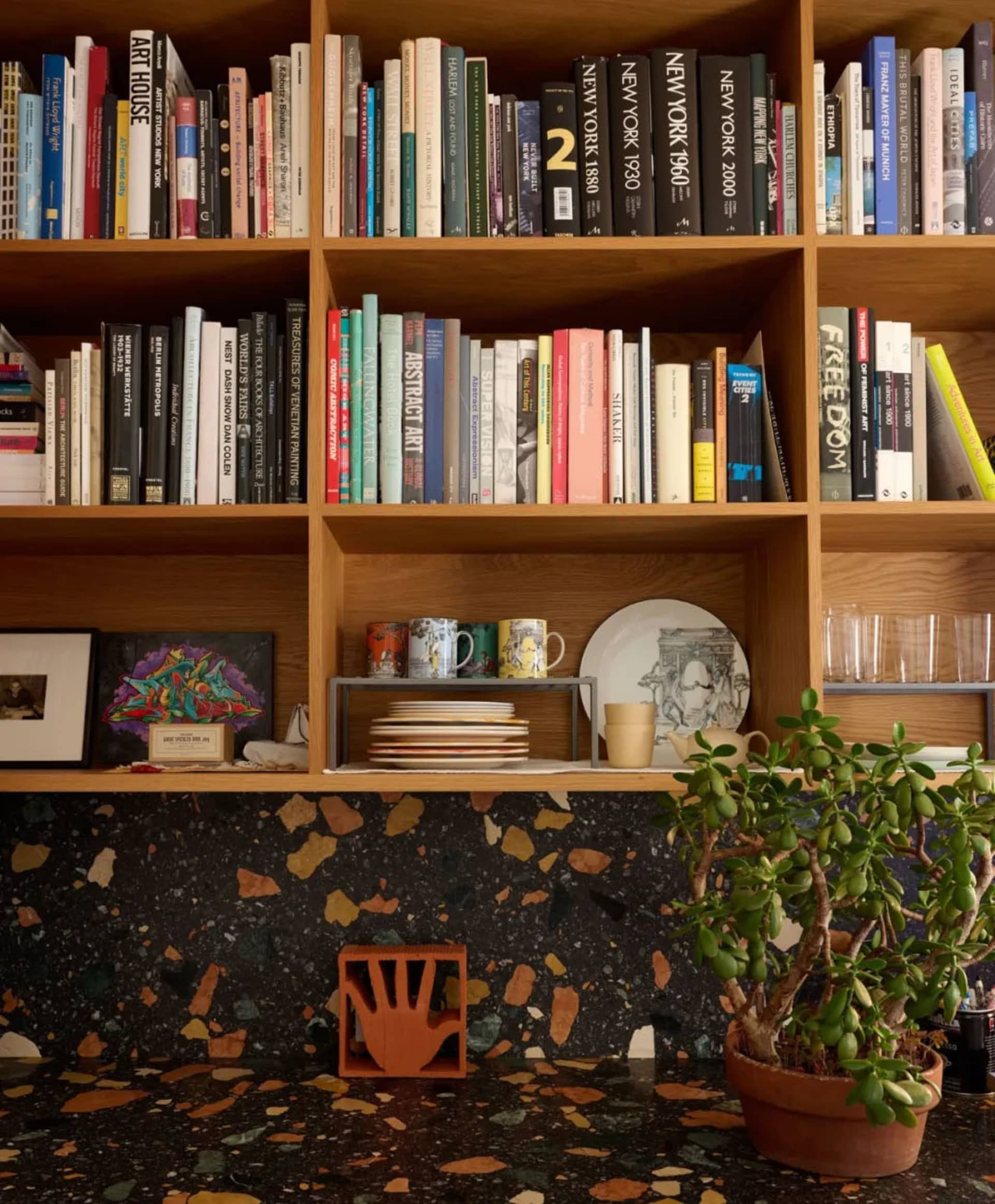 A wooden bookshelf filled with various books, arranged in an organized manner, creating a cozy and inviting atmosphere in a personal library or reading nook