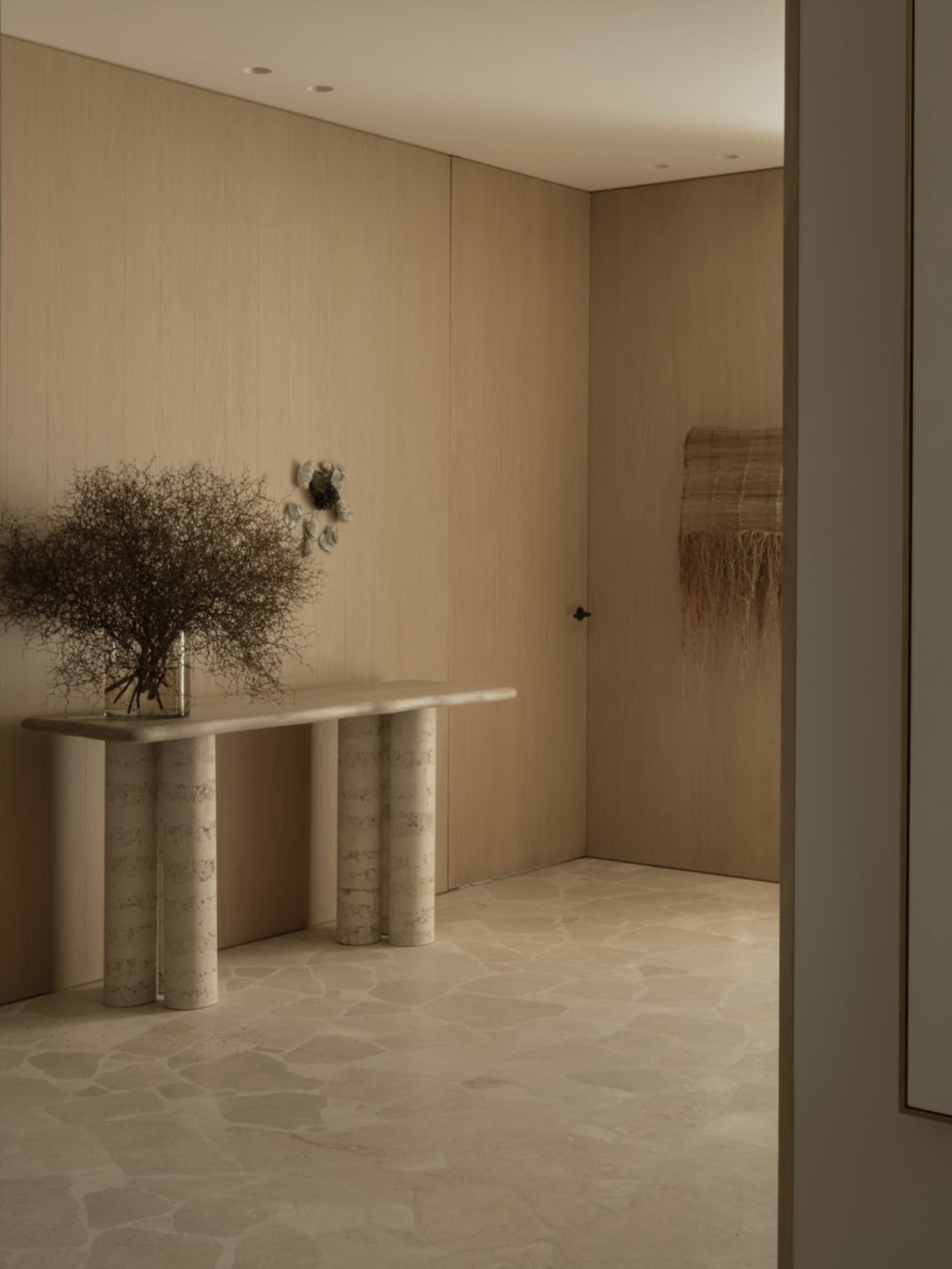 Empty room with wooden walls and floors, featuring two vases on a table in the center, creating a calm and minimalistic atmosphere