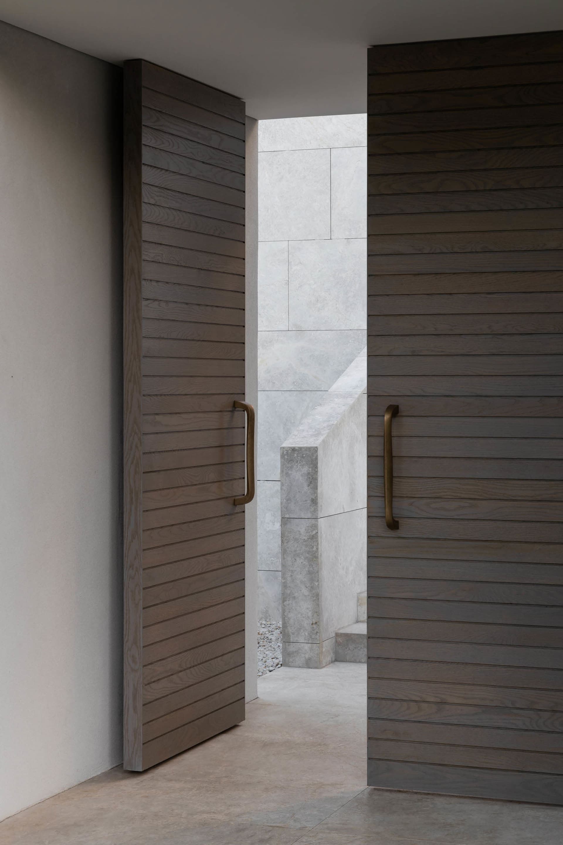 A real photo of a hallway with a stone wall, no furniture or decorations