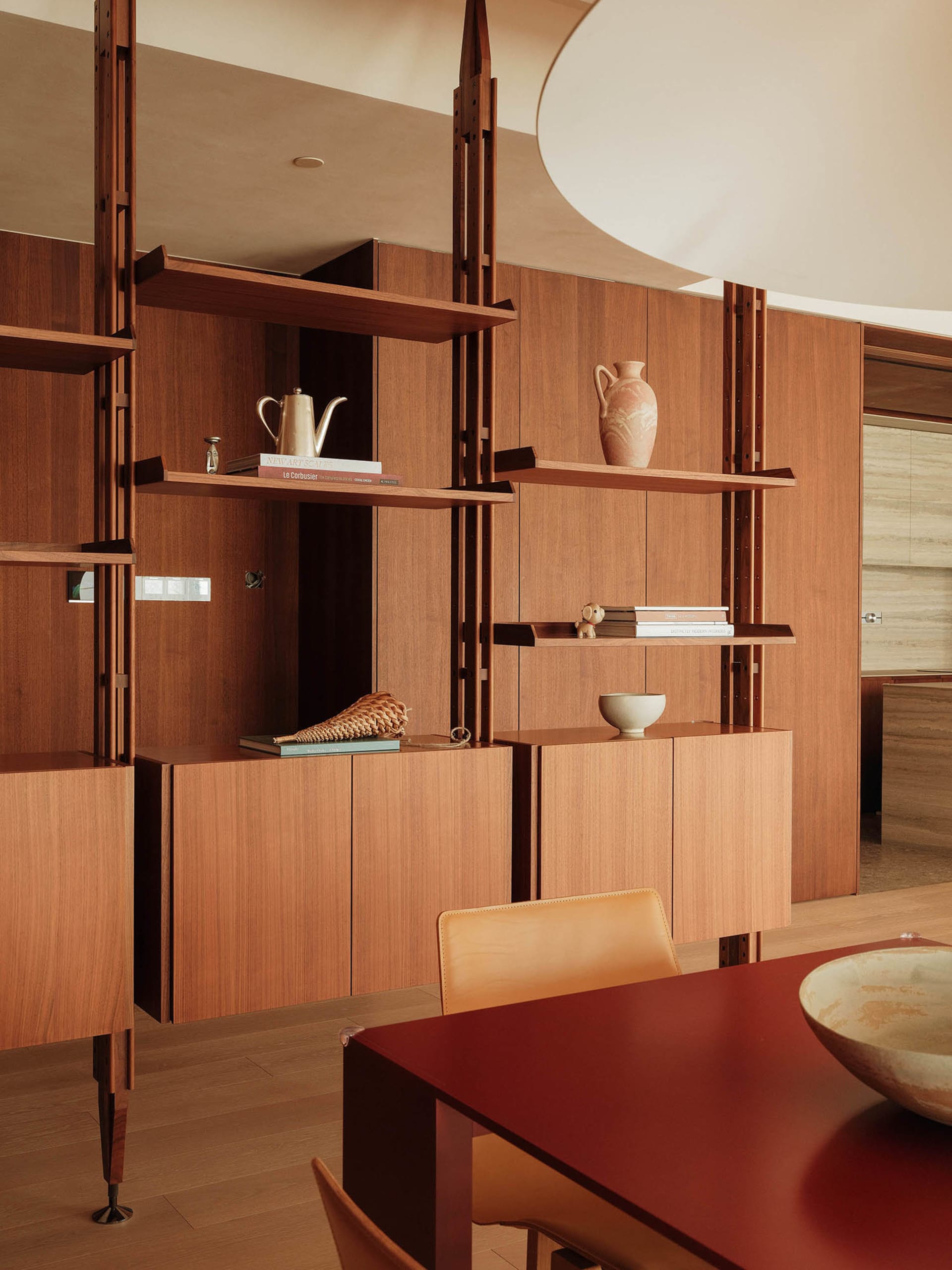 Warm and inviting living area with wooden cabinets, two chairs, and a bowl, creating a cozy and comfortable environment