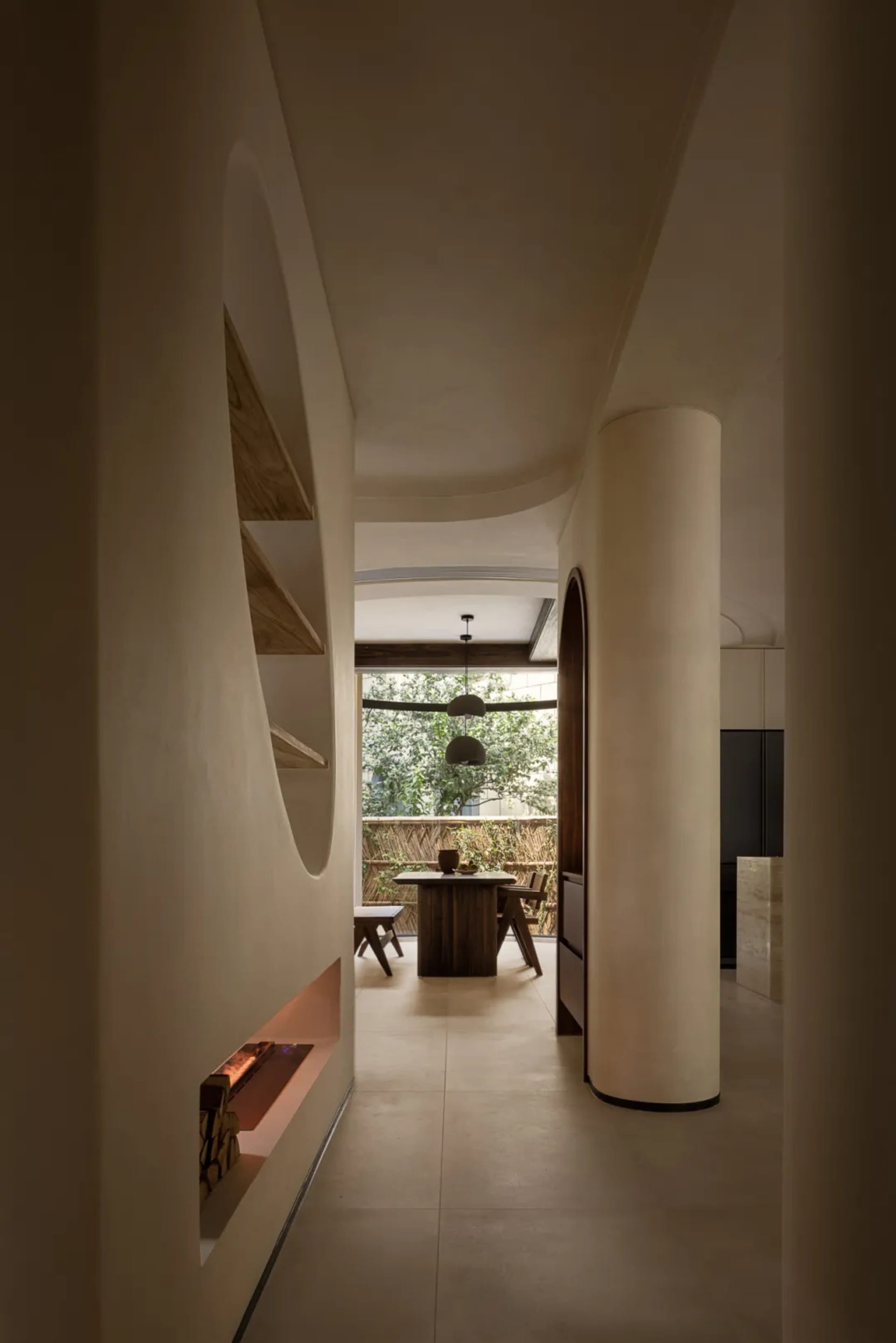 Modern living space with a spiral staircase, white walls, a wooden table, and minimal decor