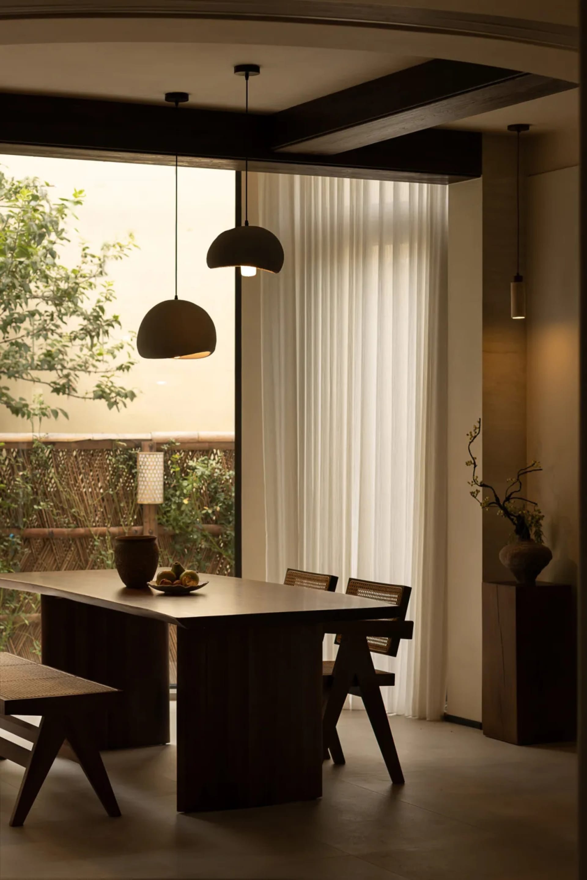 Warm and inviting kitchen space with a wooden dining table, potted plants, and a cozy atmosphere