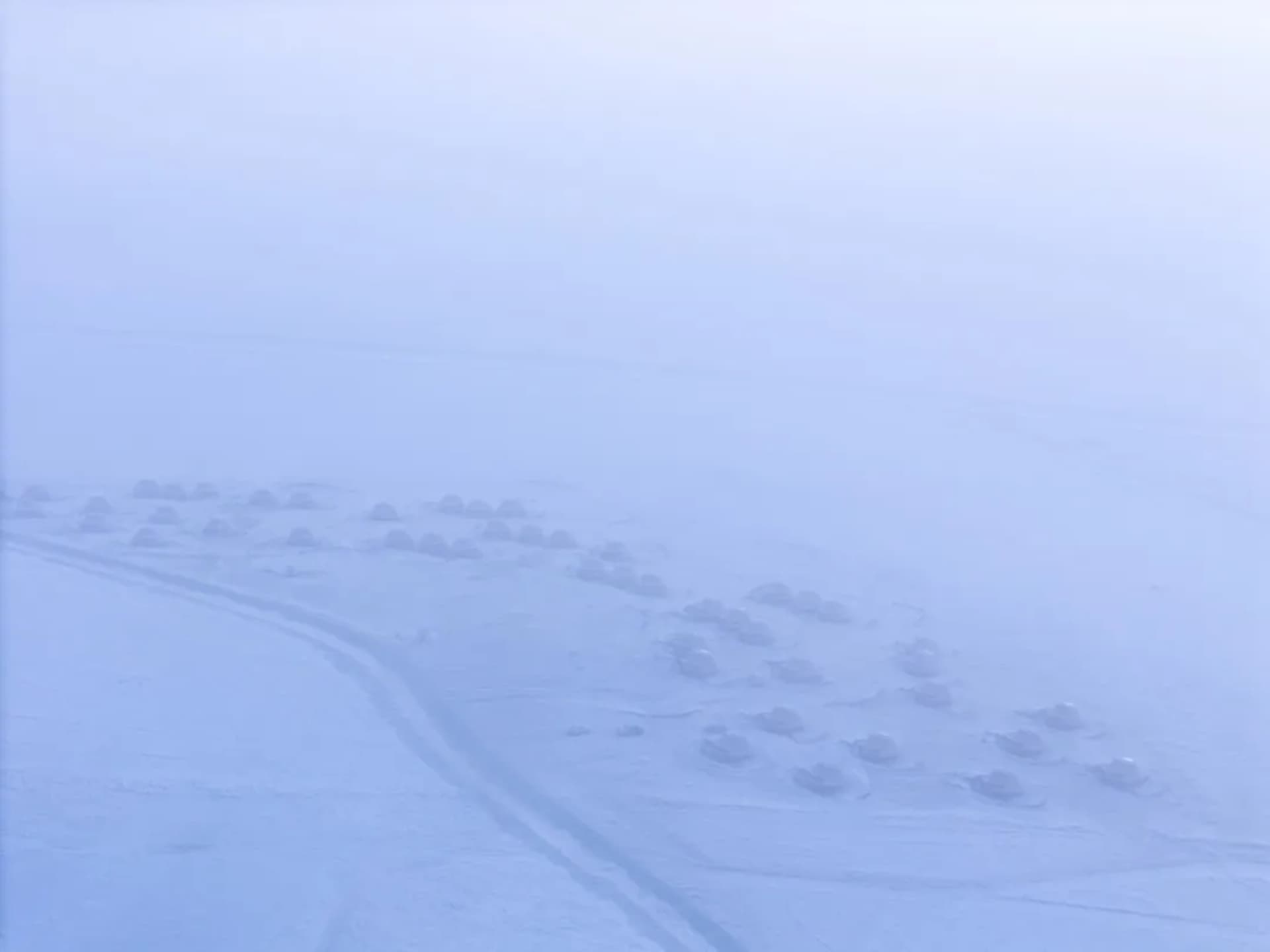 一排的小木屋，覆蓋著雪的廣闊冬天景象